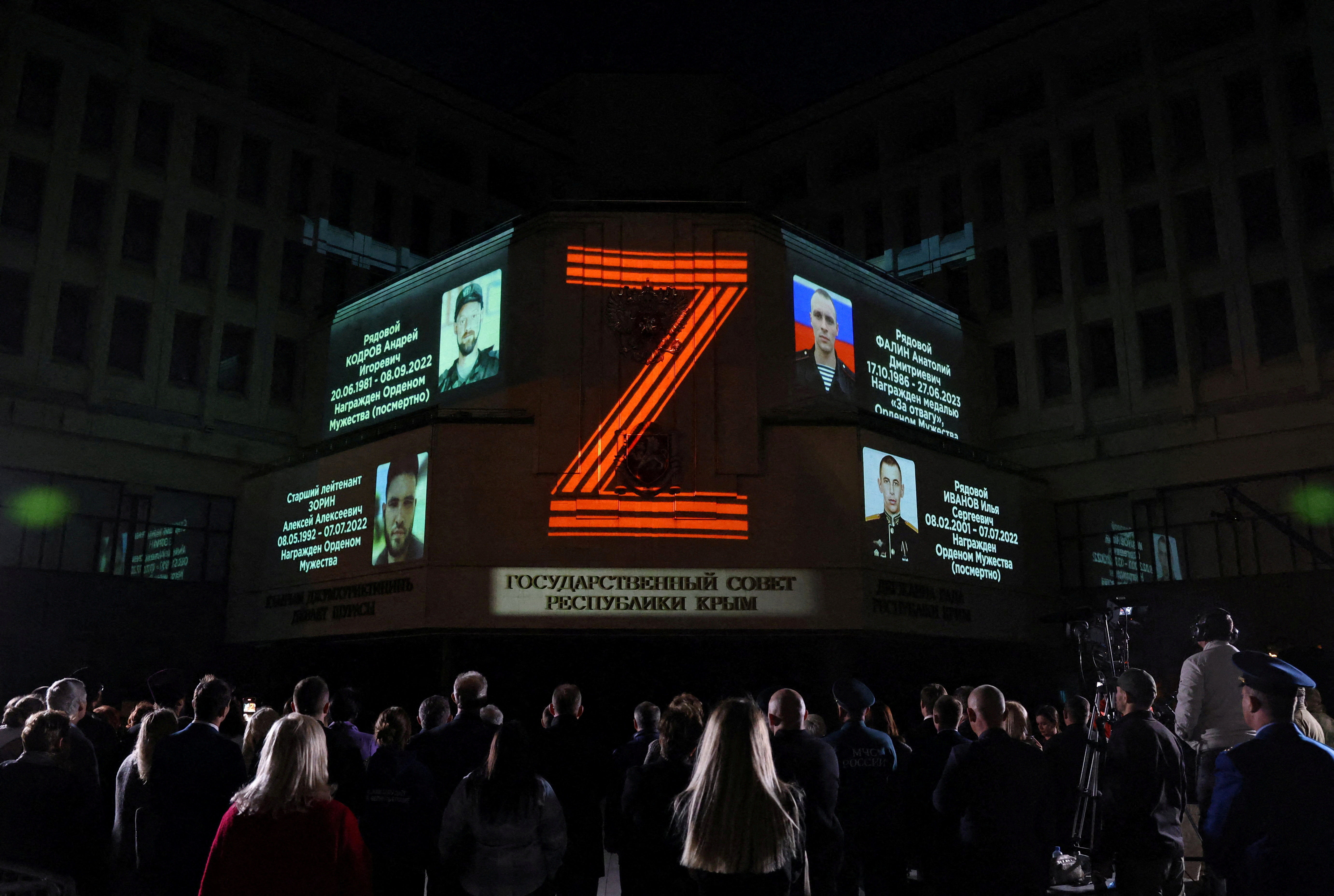 Portraits of Russian service members killed in Russia-Ukraine conflict and the symbol "Z" are projected onto the State Council building in Simferopol, Crimea April 8, 2024. REUTERS/Alexey Pavlishak TPX IMAGES OF THE DAY