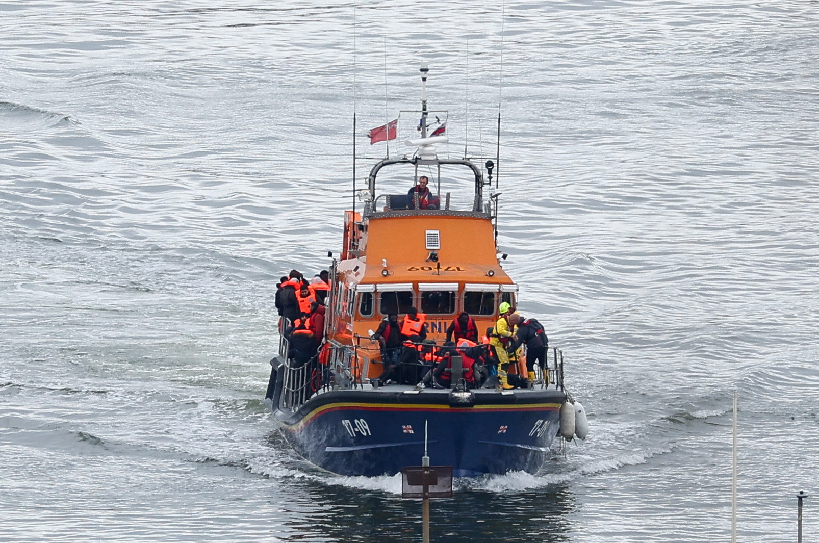 A lifeboat carrying people, believed to be migrants, navigates as seen from the Port of Dover, Britain