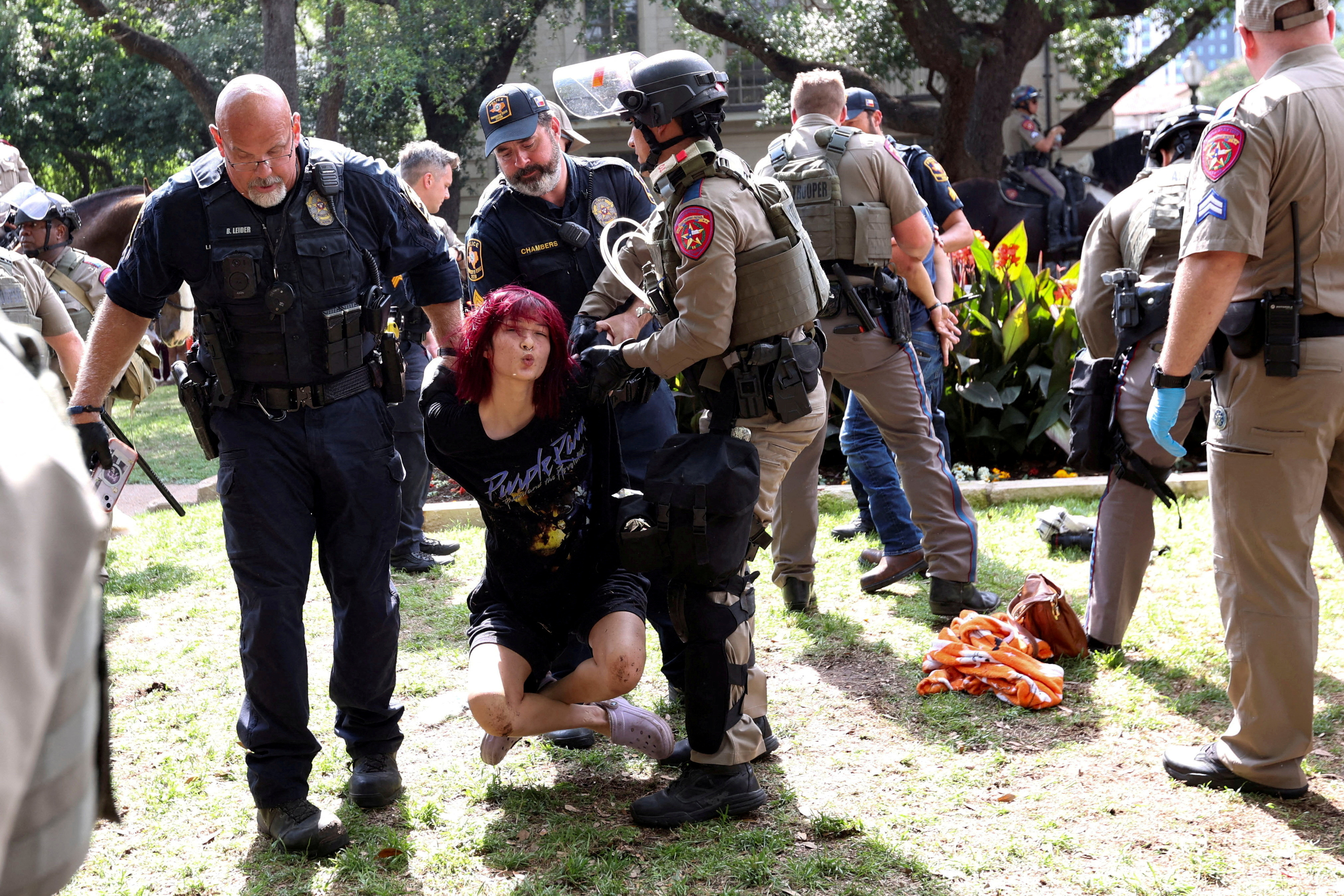 Law enforcement carry a pro-Palestinian protester at the University of Texas