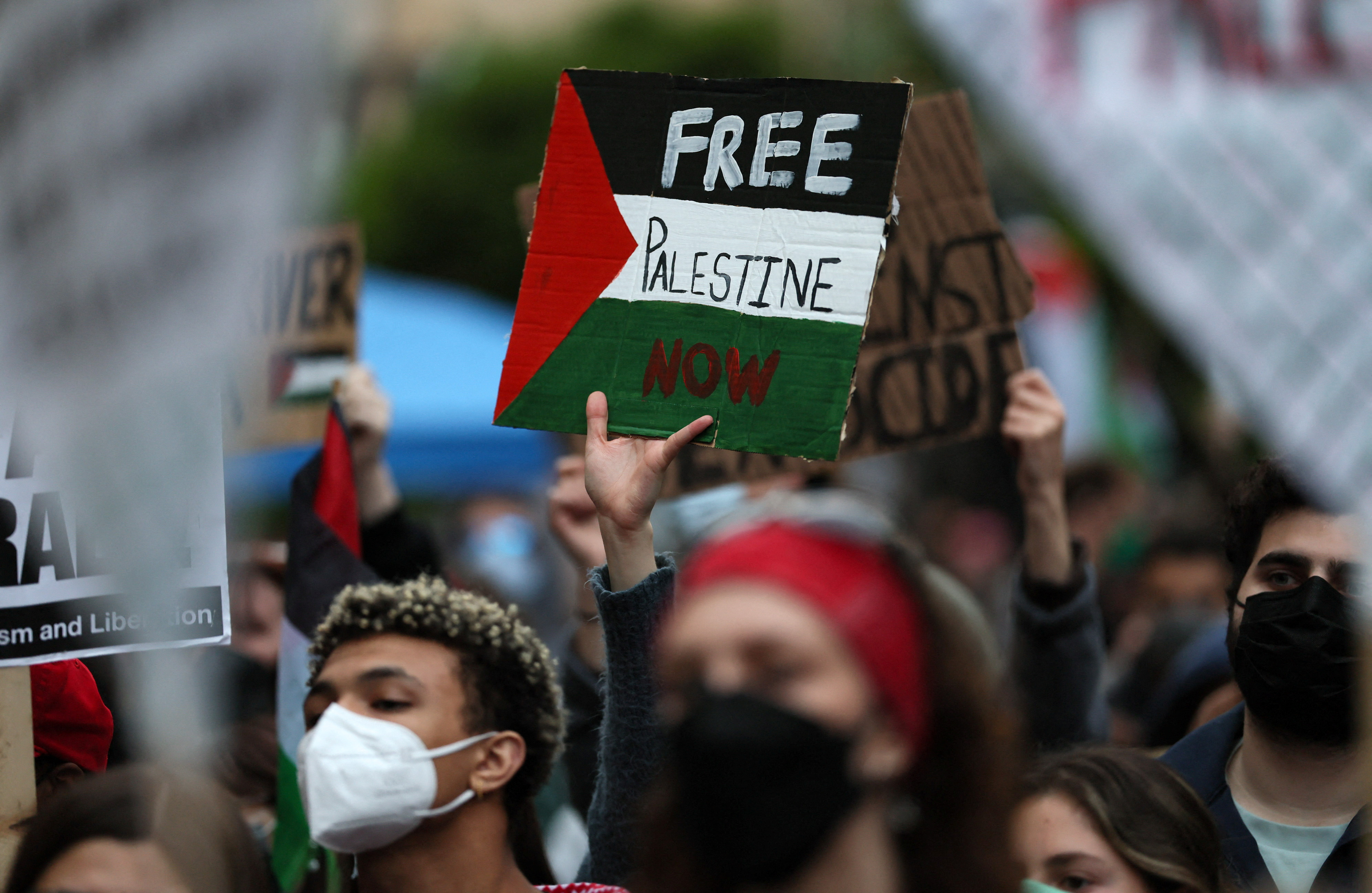 A protester holds a sign as students and others demonstrate at a protest encampment at University Yard in support of Palestinians in Gaza, during the ongoing conflict between Israel and the Palestinian Islamist group Hamas, at George Washington University in Washington, U.S., April 25, 2024. REUTERS/Leah Millis