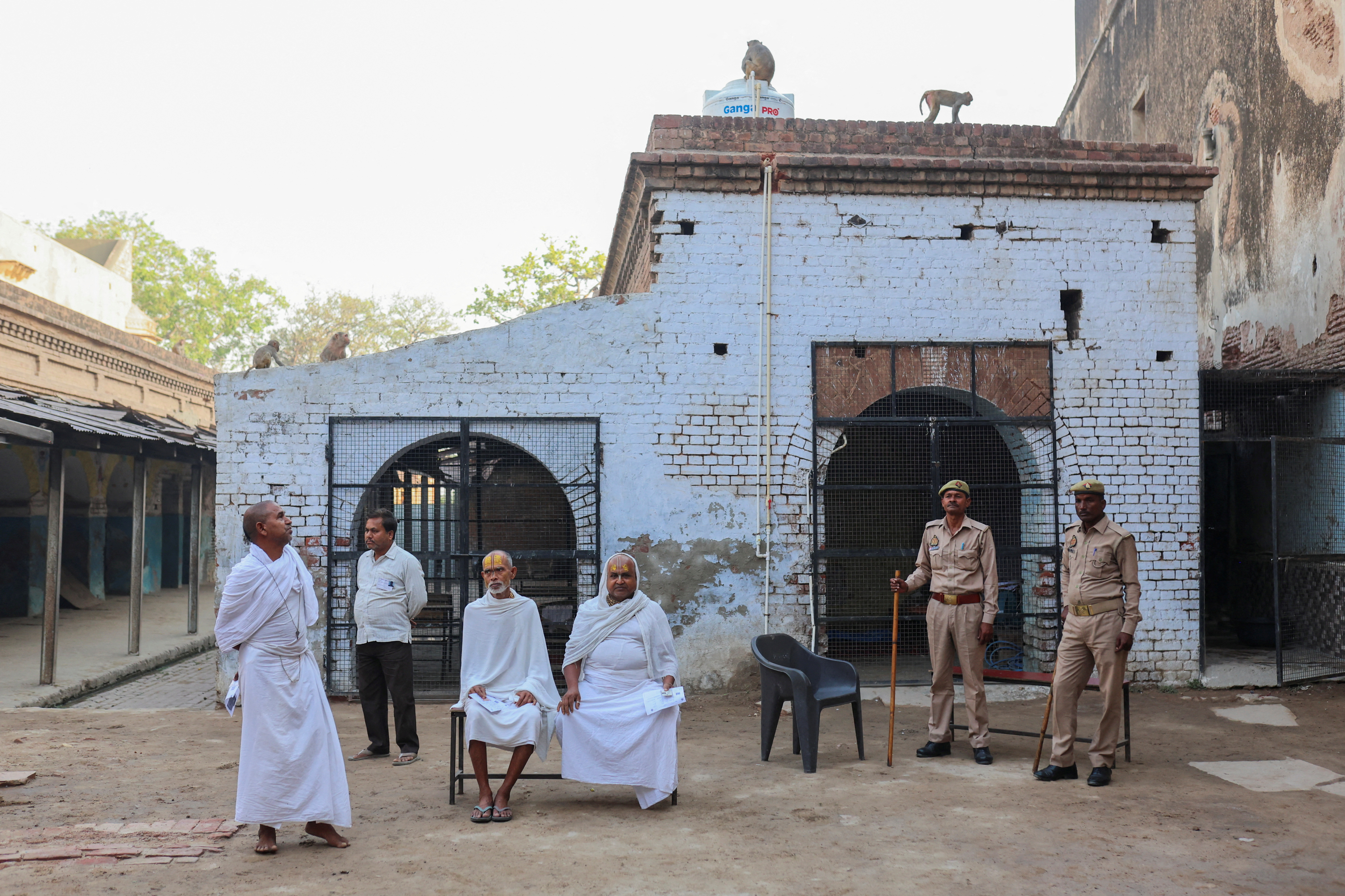 Hindu holy men, or Sadhus, wait for the voting to start during the second phase of the general election in Vrindavan, in the northern Indian state of Uttar Pradesh, India, April 26