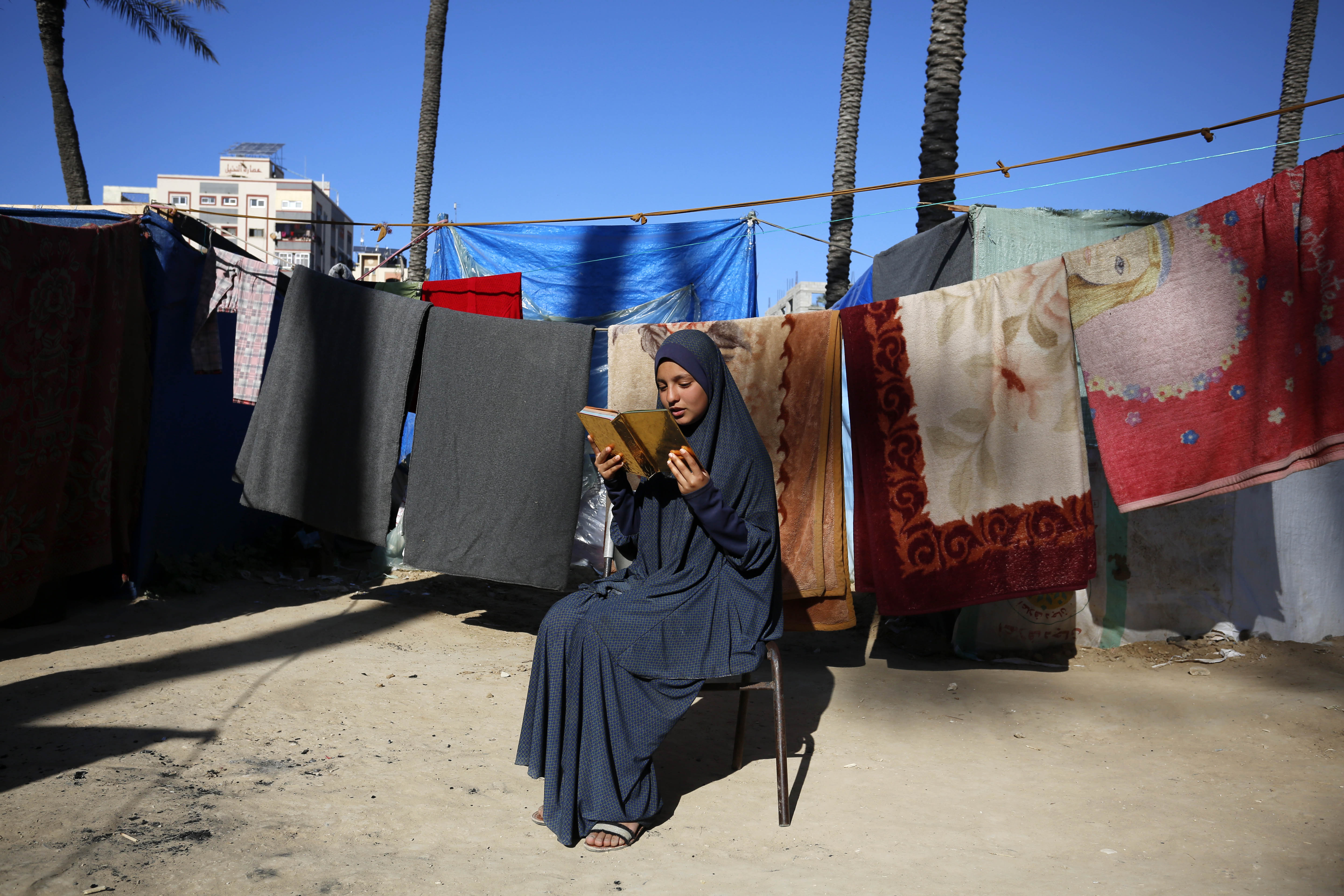 Palestinians living in tents are viewed in Deir Al-Balah in the Gaza Strip on April 6, 2024. Palestinians who left their homes and took refuge in Deir Balah city due to the ongoing Israeli attacks on the Gaza Strip are struggling to survive under difficult conditions. Palestinian families are trying to maintain their daily lives in makeshift tents under limited means and difficult conditions. Palestinians living in tents spend the last days of Ramadan reading the Holy Quran. And some of them hung the decorations they prepared specially for Ramadan in their tents
