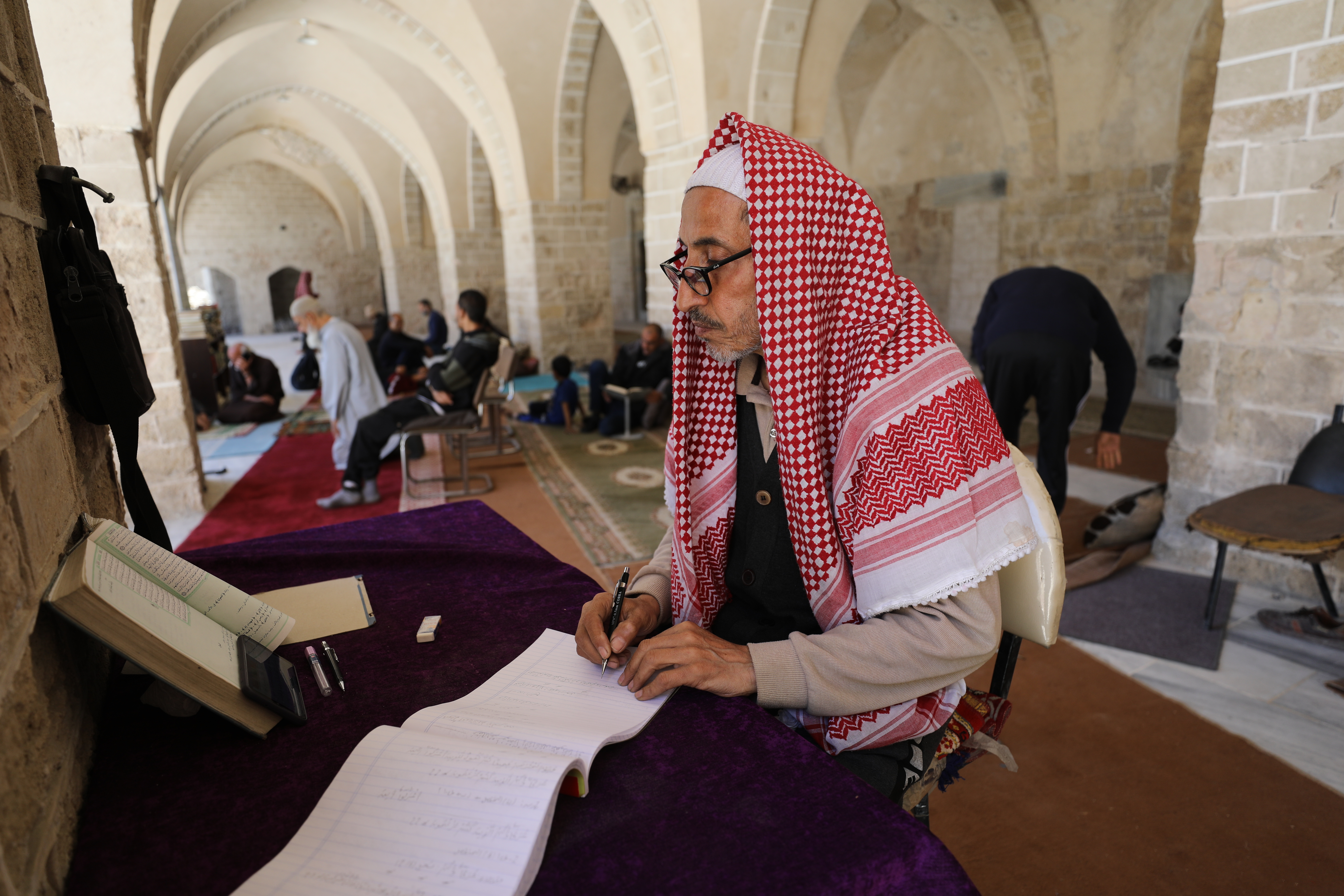 Palestinians gather to read the Holy Qur'an during the last days of Ramadan, in the remaining part of the historic "Great Omari Mosque," also known as the "Great Mosque of Gaza,"