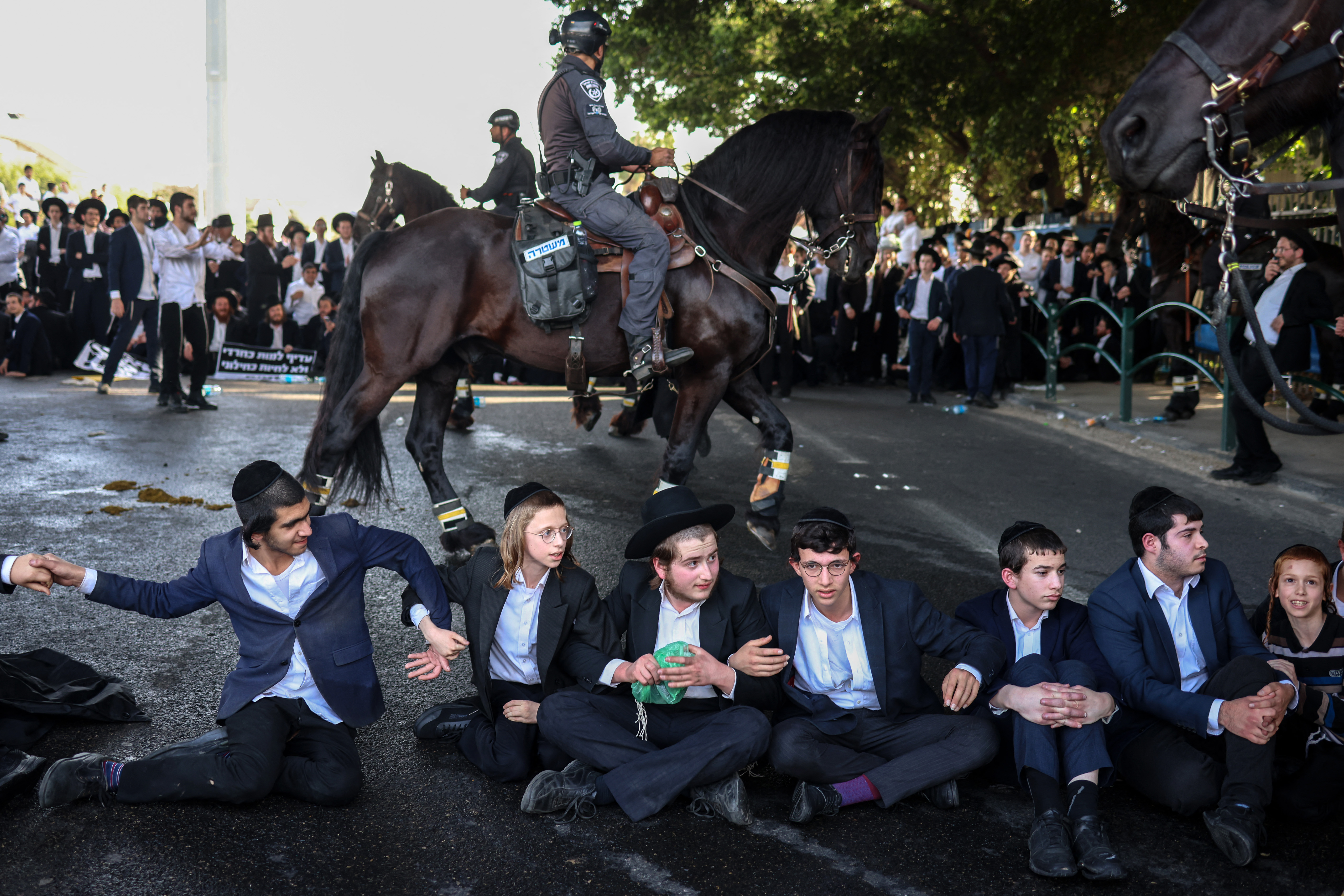Ultra Orthodox Jews block a highway in Bnei Brak as they protest against their conscription into the Israeli armed forces on April 1, 2024. - Israel's decades-old exemption from military service for ultra-Orthodox Jews is poised to end on April 1, a divisive move that imperils the coalition government as the nation is at war with Hamas. (Photo by Oren ZIV / AFP)