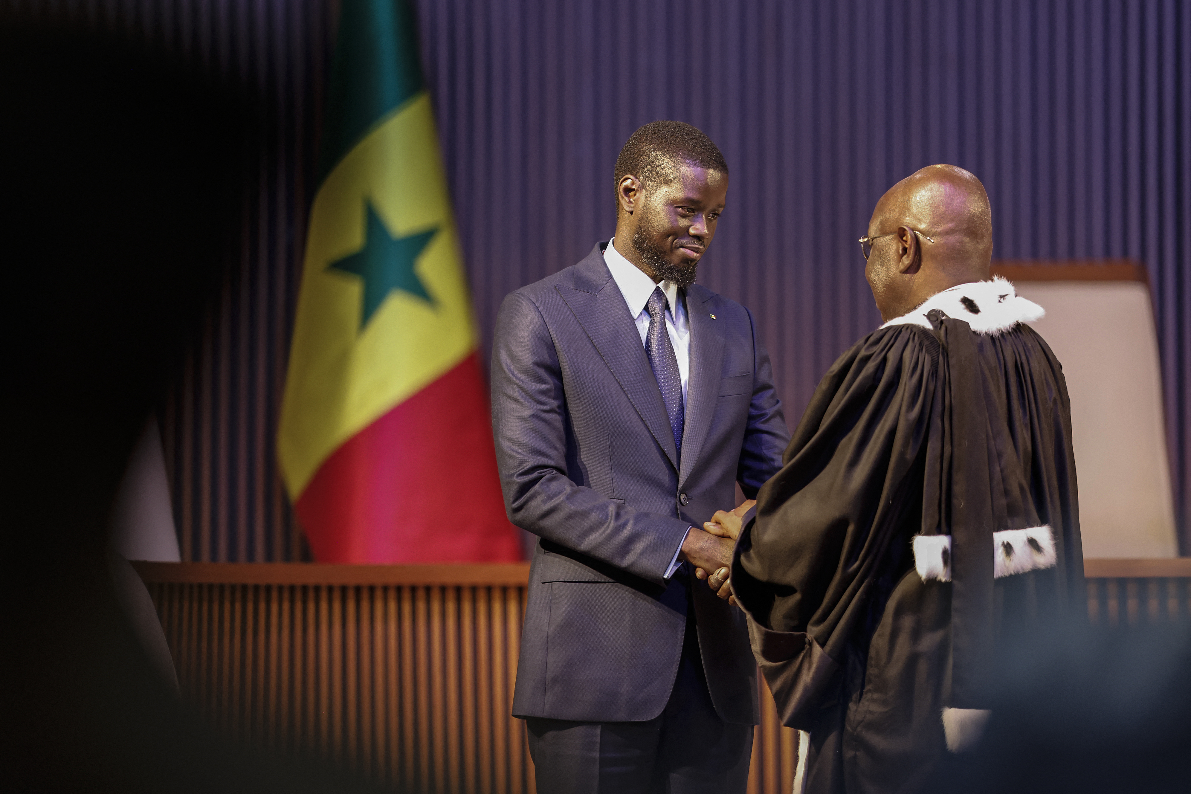 Bassirou Diomaye Faye (L) is sworn in as Senegal's President at an exhibition centre in the new town of Diamniadio near the capital Dakar