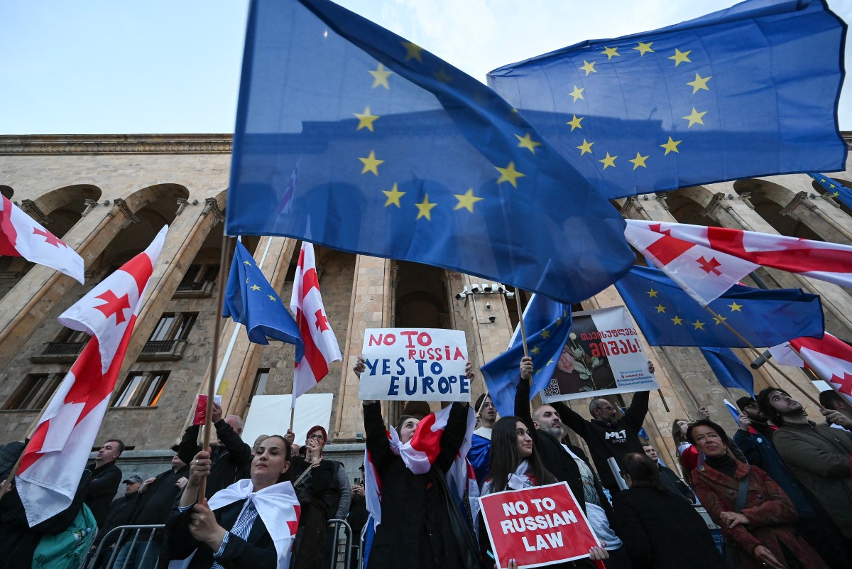 Georgian pro-democracy groups activists protest against a repressive "foreign influence" bill outside the parliament