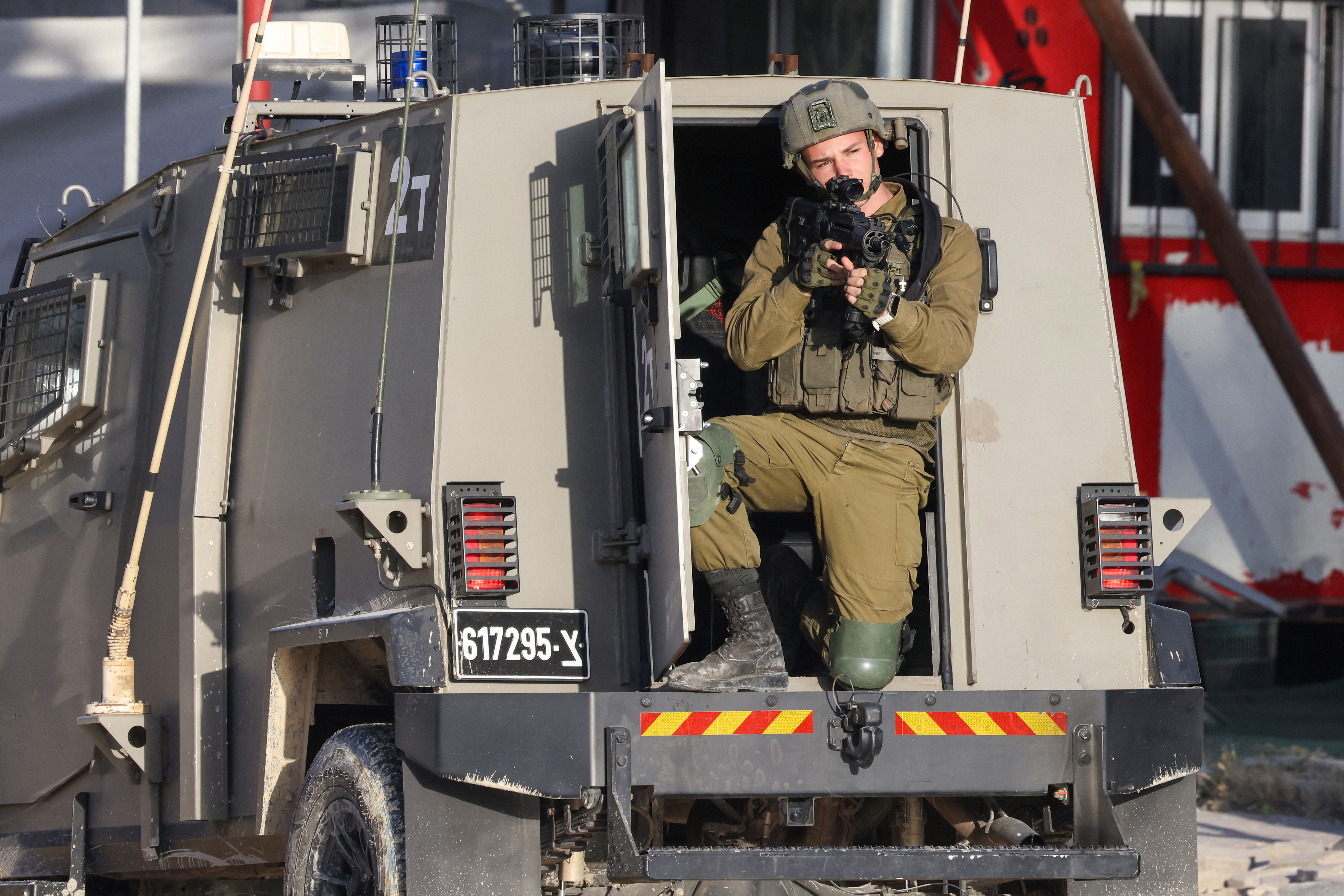 An Israeli soldier aims his rifle during a raid in the Nur Shams refugee camp in the occupied West Bank on April 19, 2024