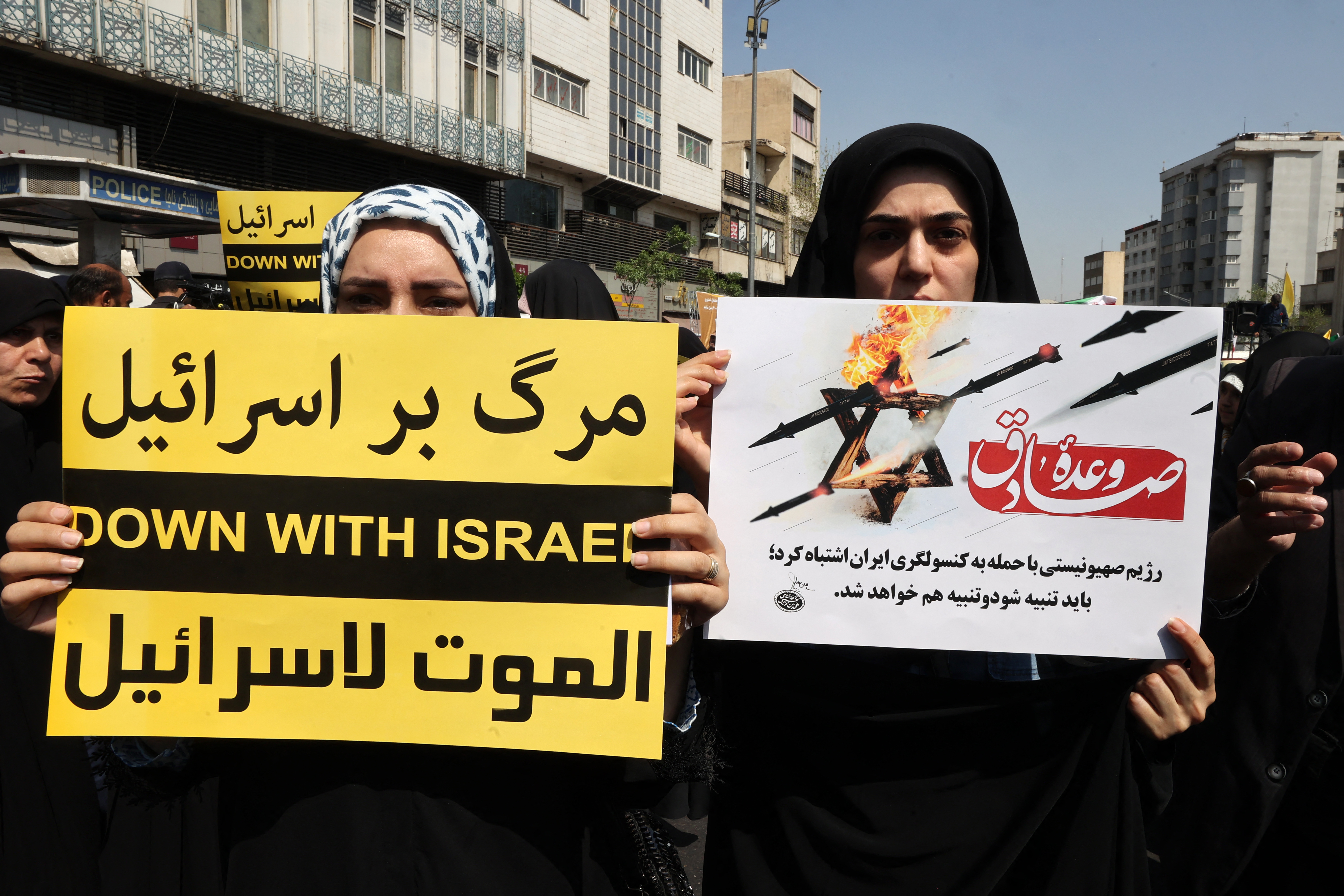 Iranians wave the flags of Palestine and Iran they gather during an anti-Israel demonstration after the Friday noon prayer in Tehran