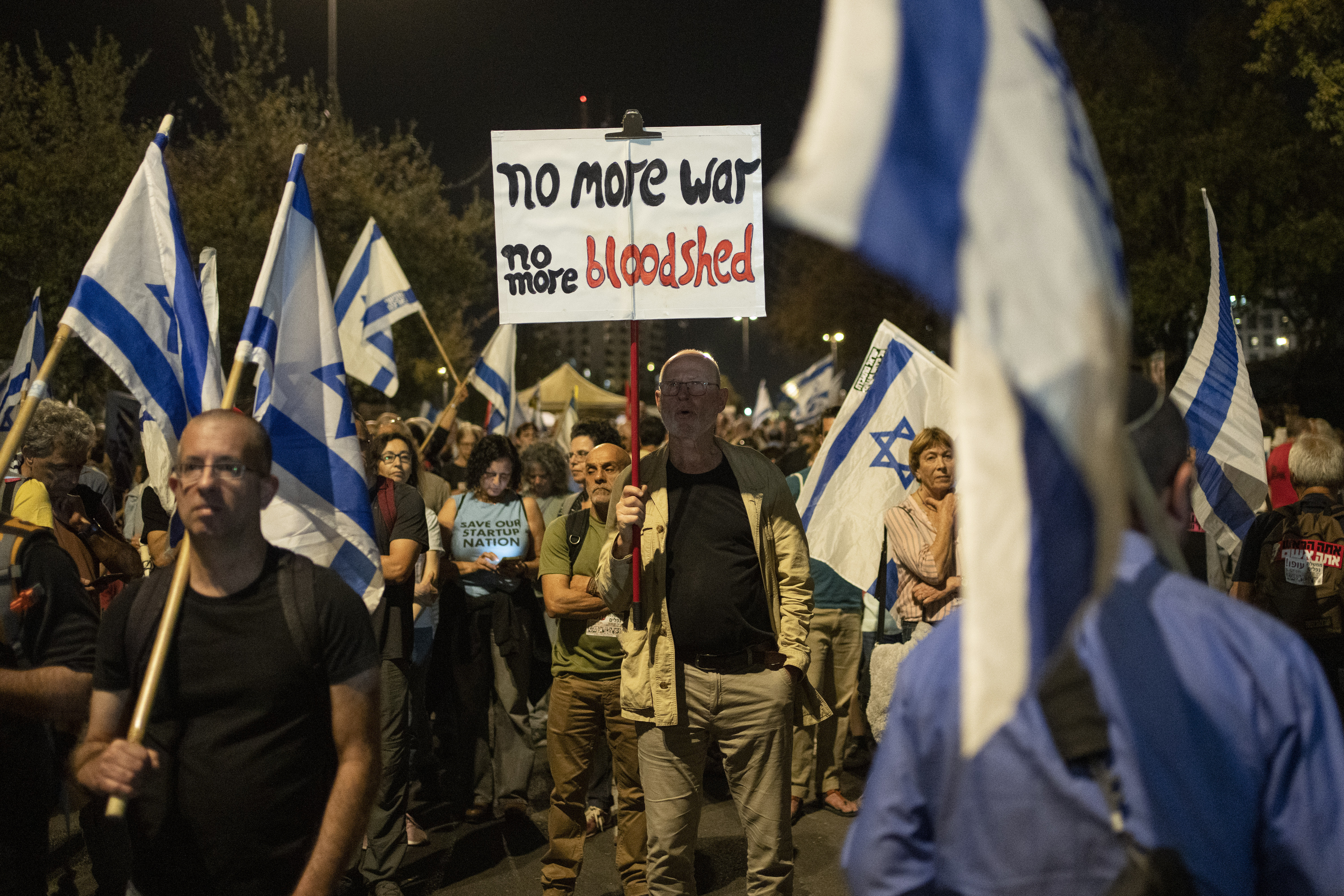 A man holds up a sign during a protest against Israeli Prime Minister Benjamin Netanyahu's government and to call for the release of hostages held in the Gaza Strip by the Hamas militant group near the Knesset, Israel's parliament, in Jerusalem