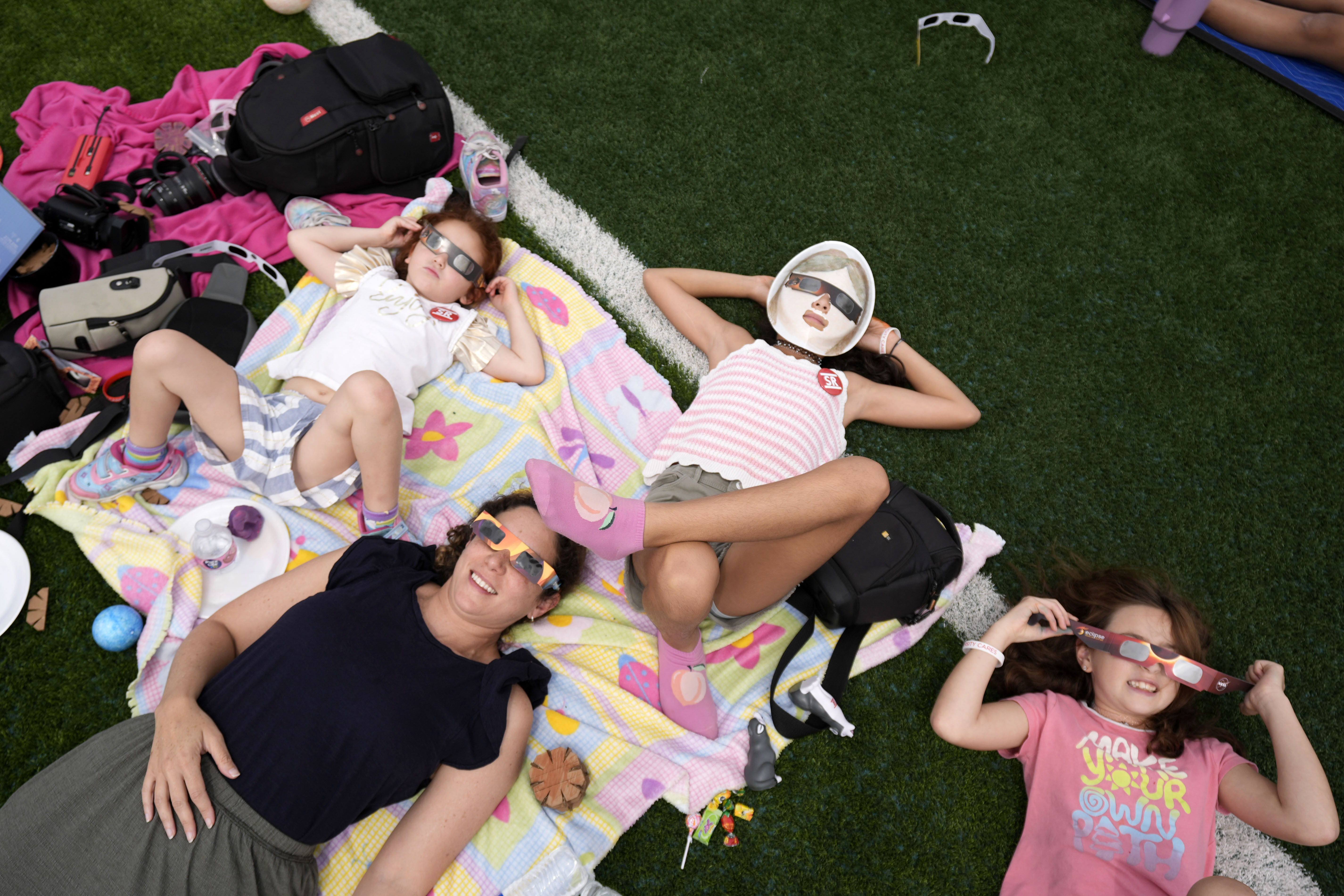 Spectators watch as the moon partially covers the sun during a total solar eclipse, in Eagle Pass, Texas, April 8