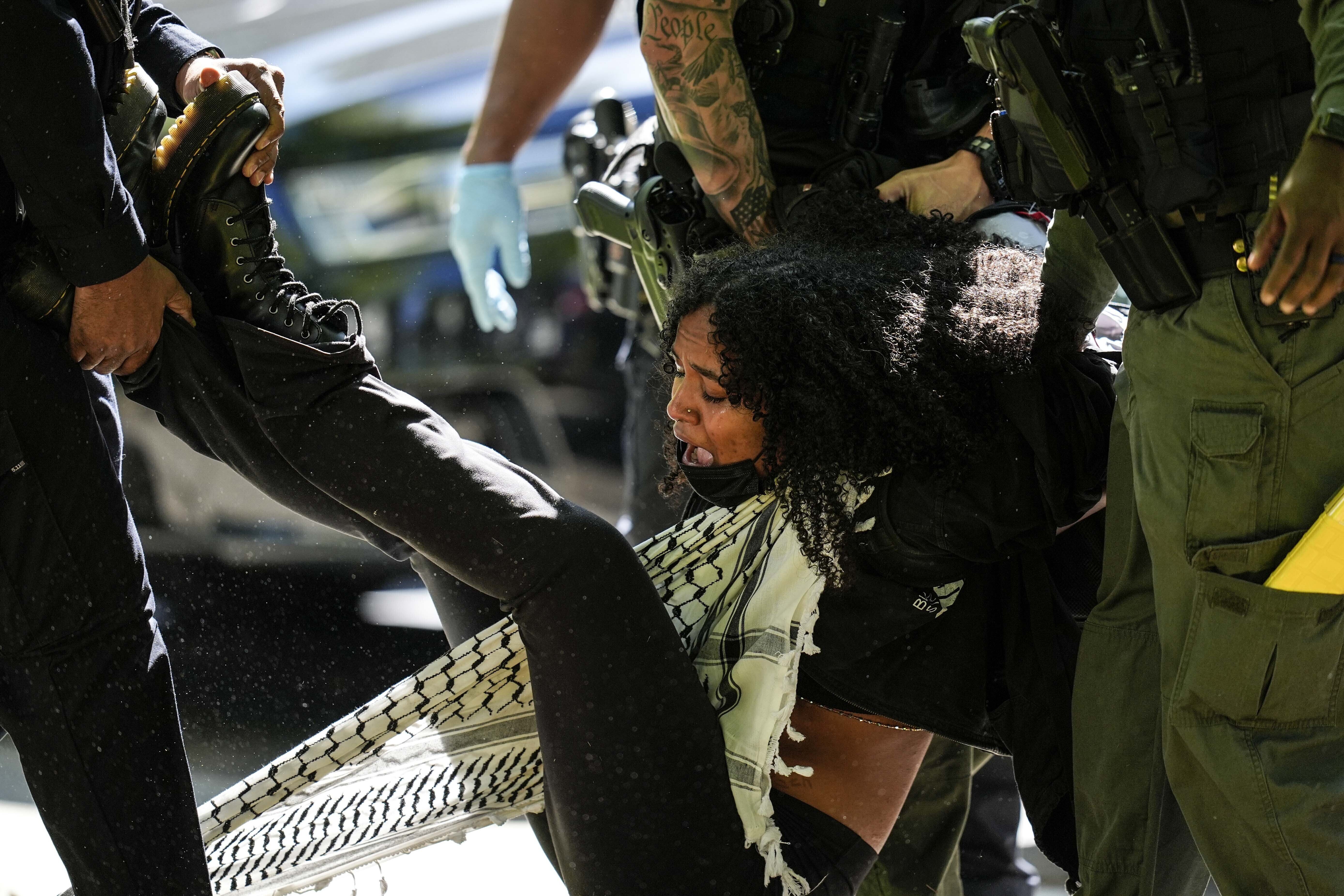 Authorities detain a protester on the campus of Emory University during a pro-Palestinian demonstration, in Atlanta, Georgia, April 25