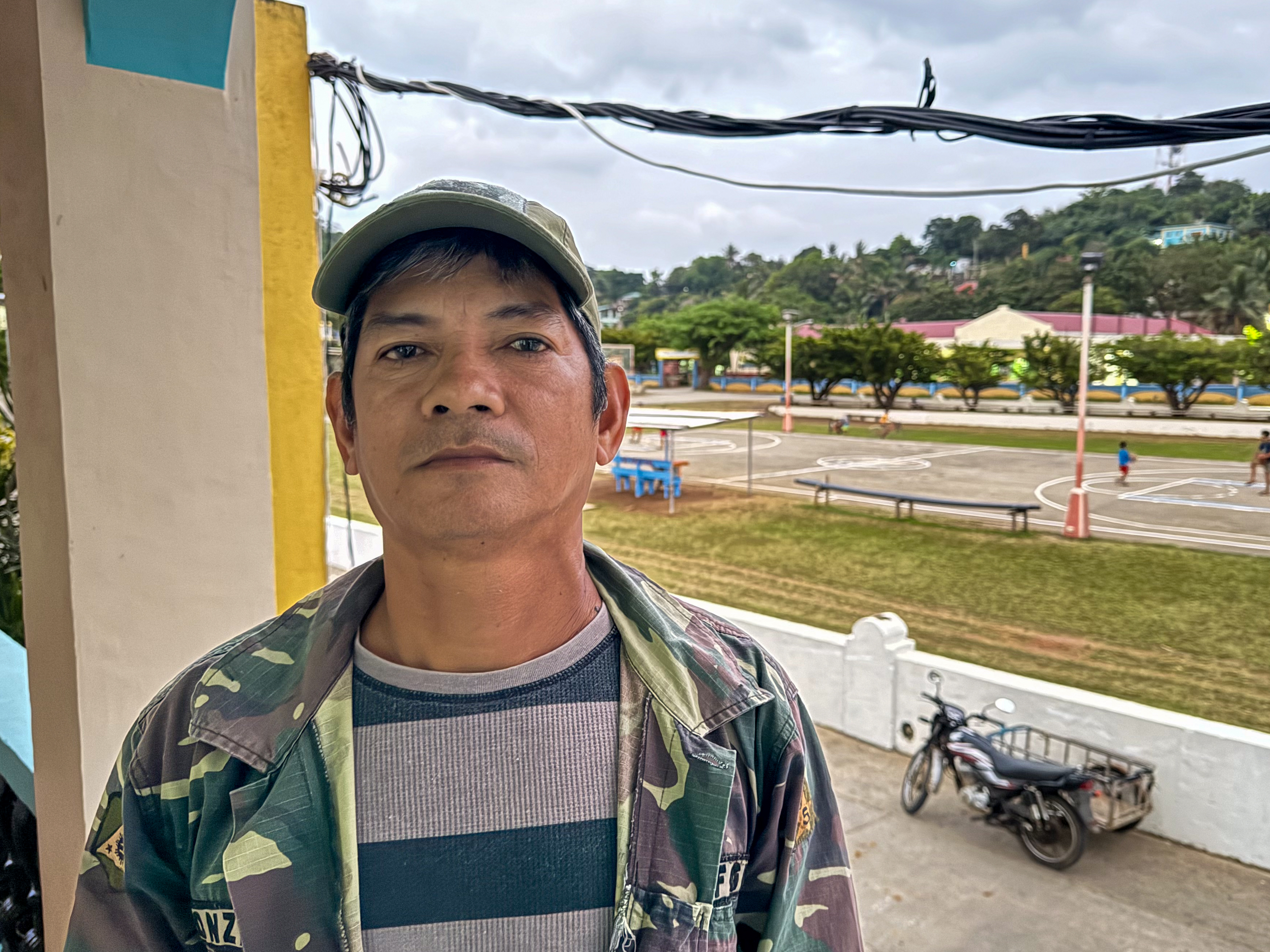 Victor Gonzales, Itbayat’s representative to the government’s Indigenous commission. He is wearing a jacket and baseball cap and is standing on a balcony.