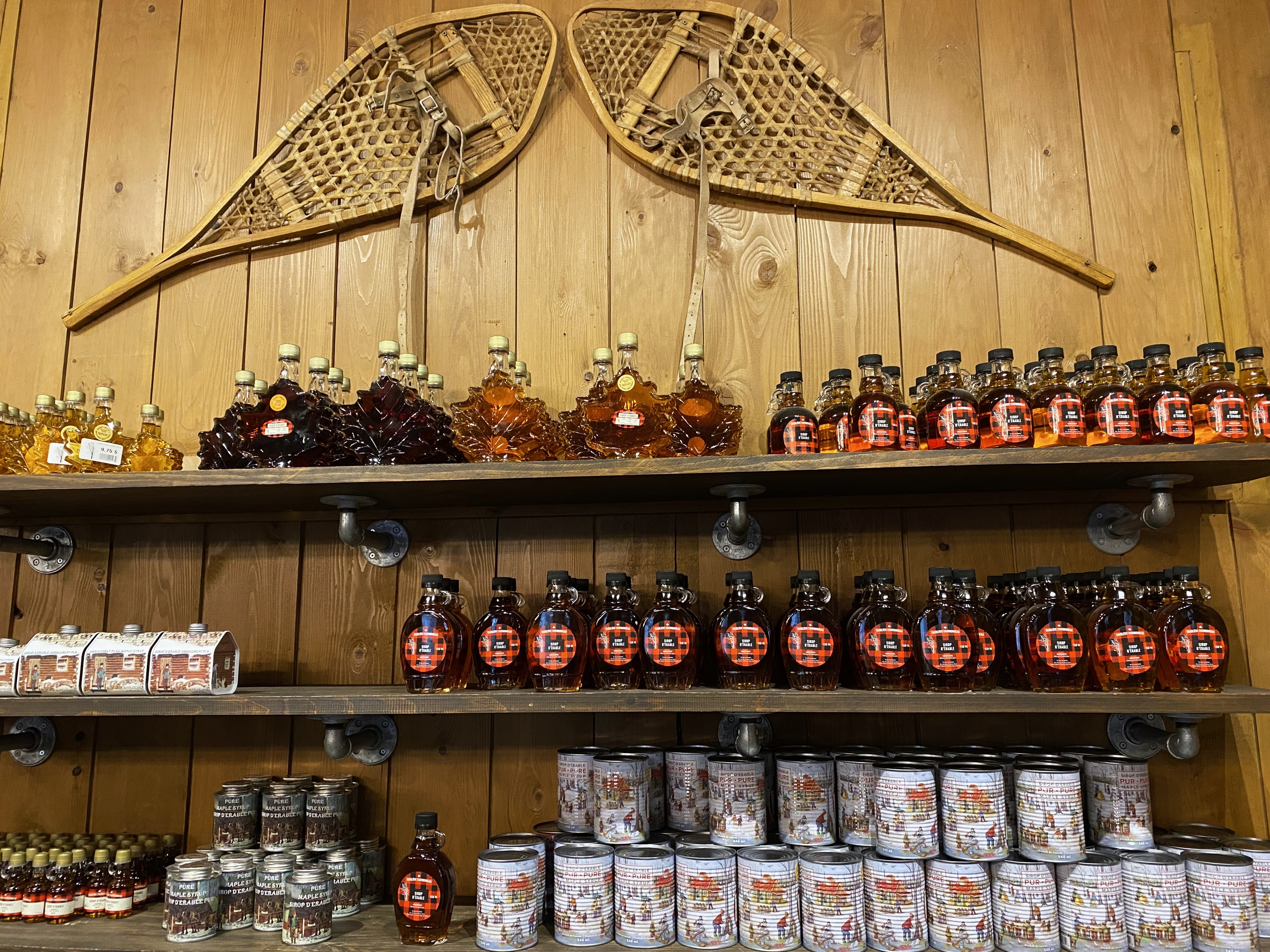 Maple syrup lines a shelf at a sugar shack in Mont-Saint-Gregoire, Quebec, Canada