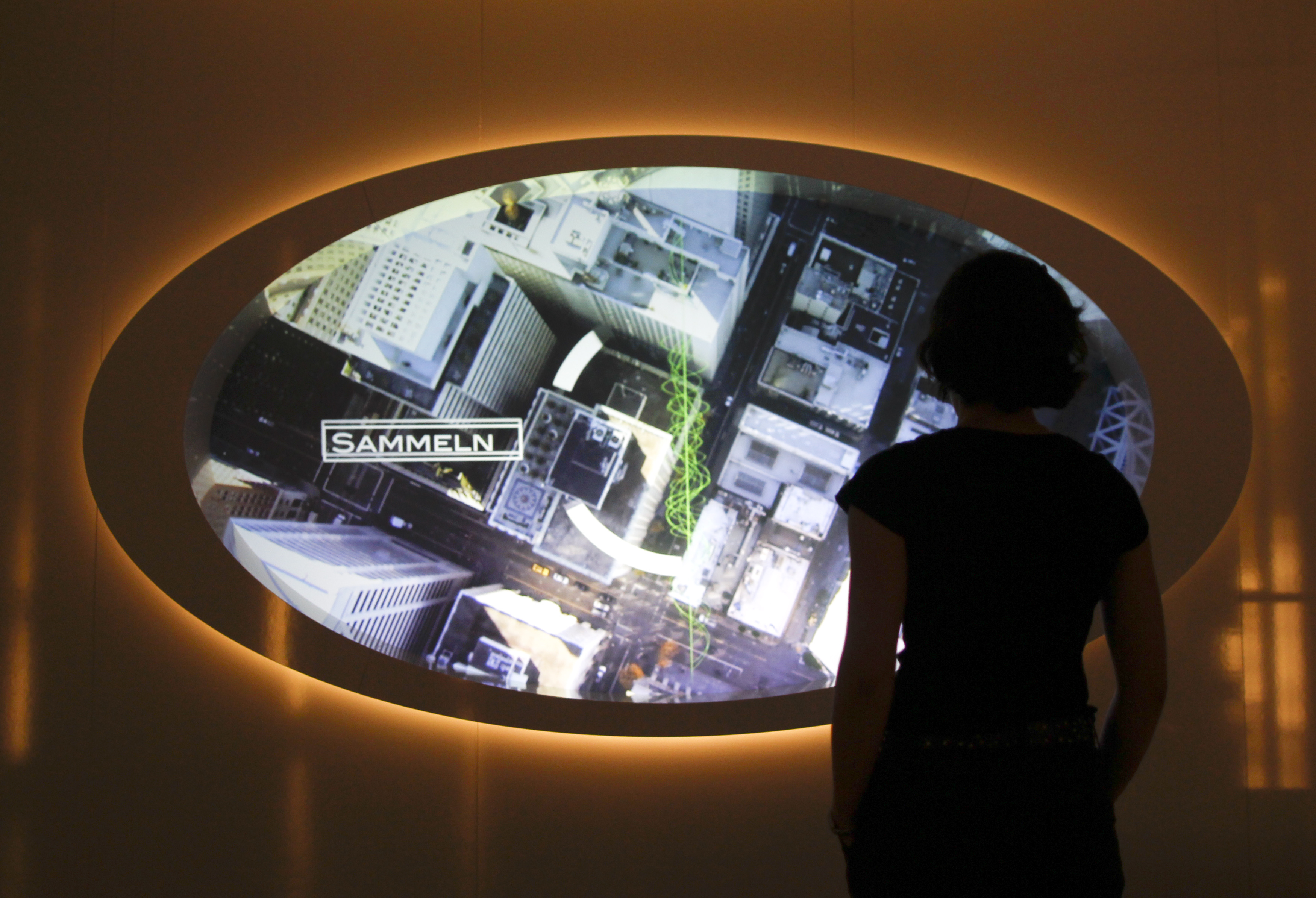 A visitor looks at a video screen at the 'Top Secret' Spy Museum in Oberhausen, July 10, 2013