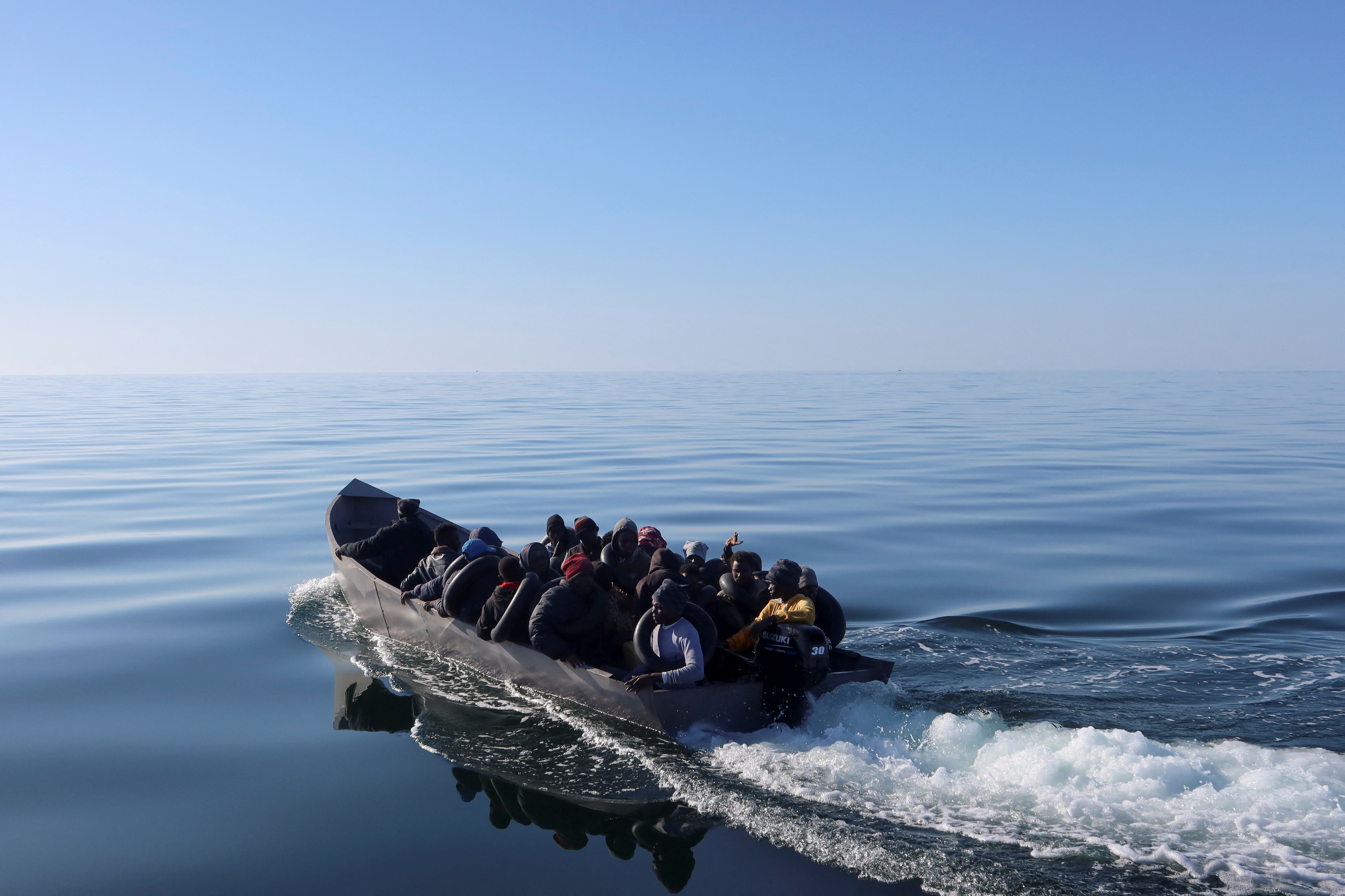 Migrants navigate on a boat as they are spotted by Tunisian coast guards at sea during their attempt to cross to Italy, off Sfax, Tunisia April 27, 2023. REUTERS/Jihed Abidellaoui