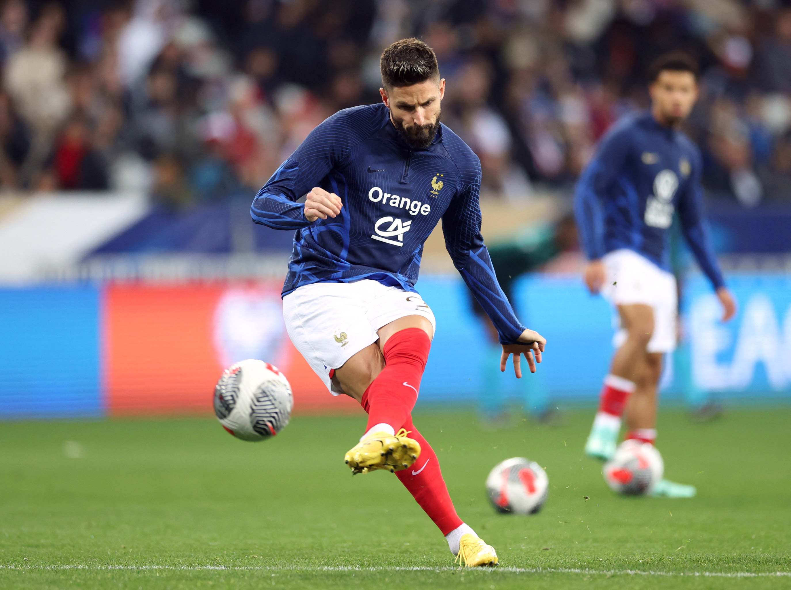 Player kicks football.