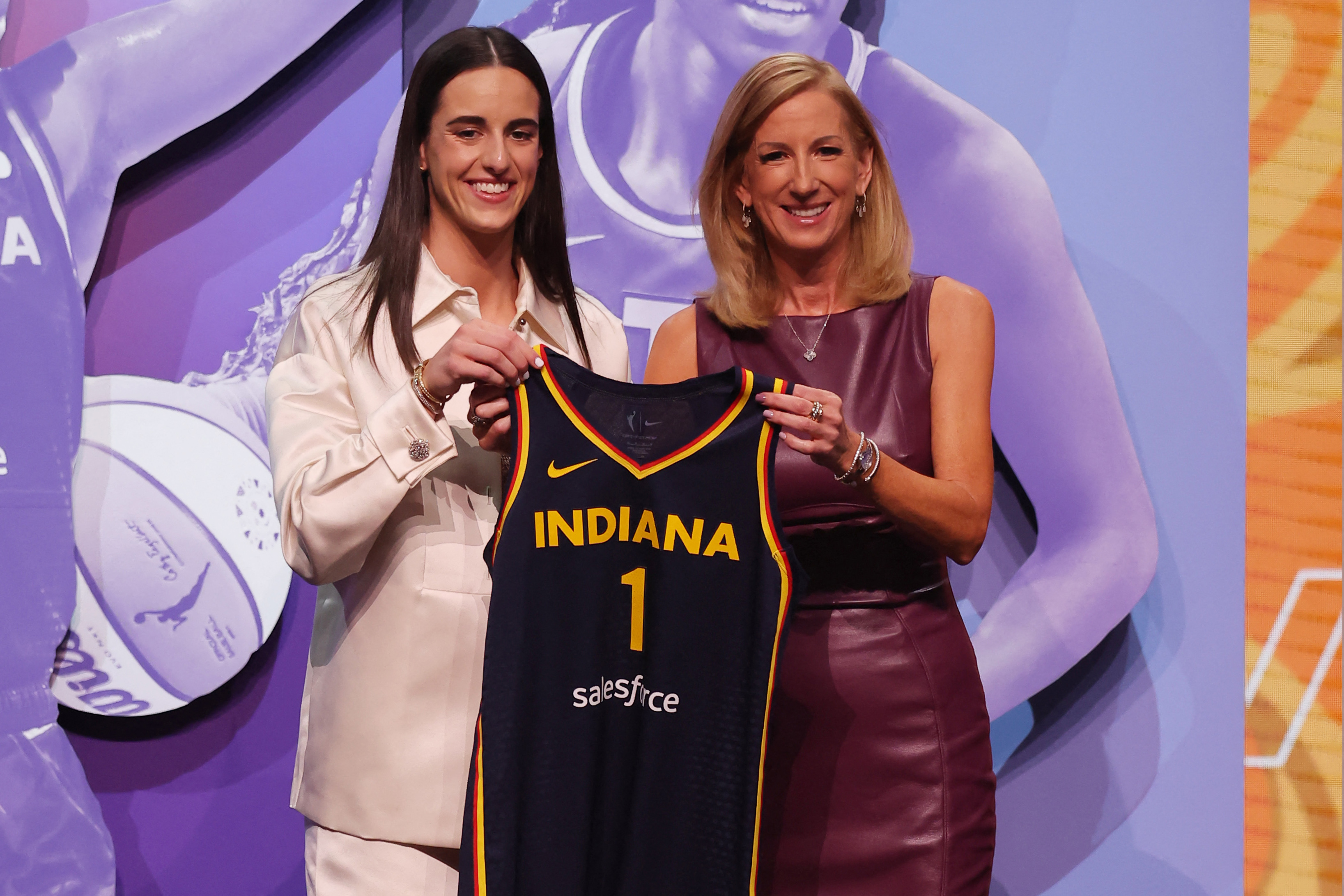 Caitlin Clark poses with WNBA Commissioner Cathy Engelbert after being selected number-one in the 2024 draft