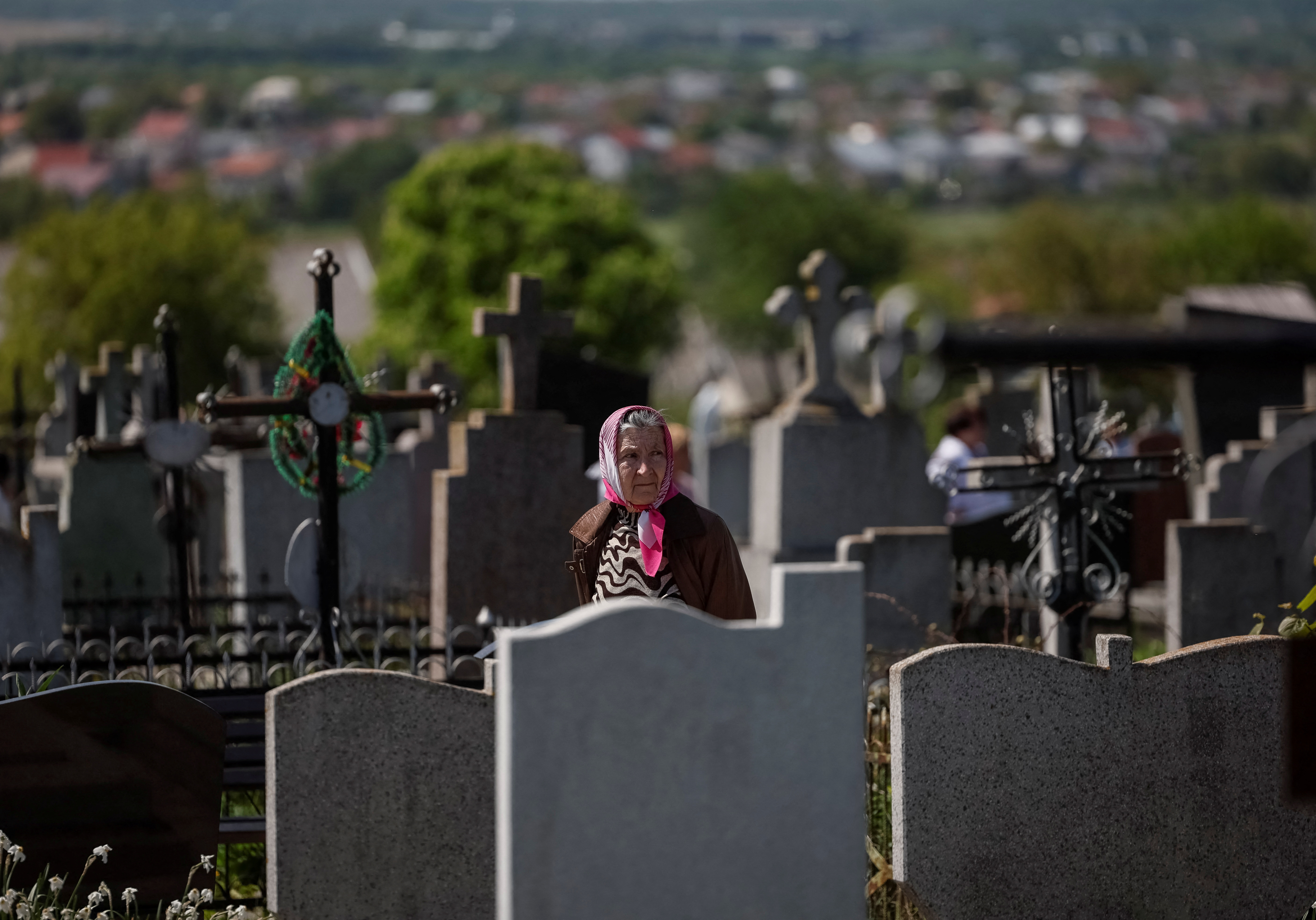 A believer visits the graves of her loved ones to pay homage to them on the day of Easter,