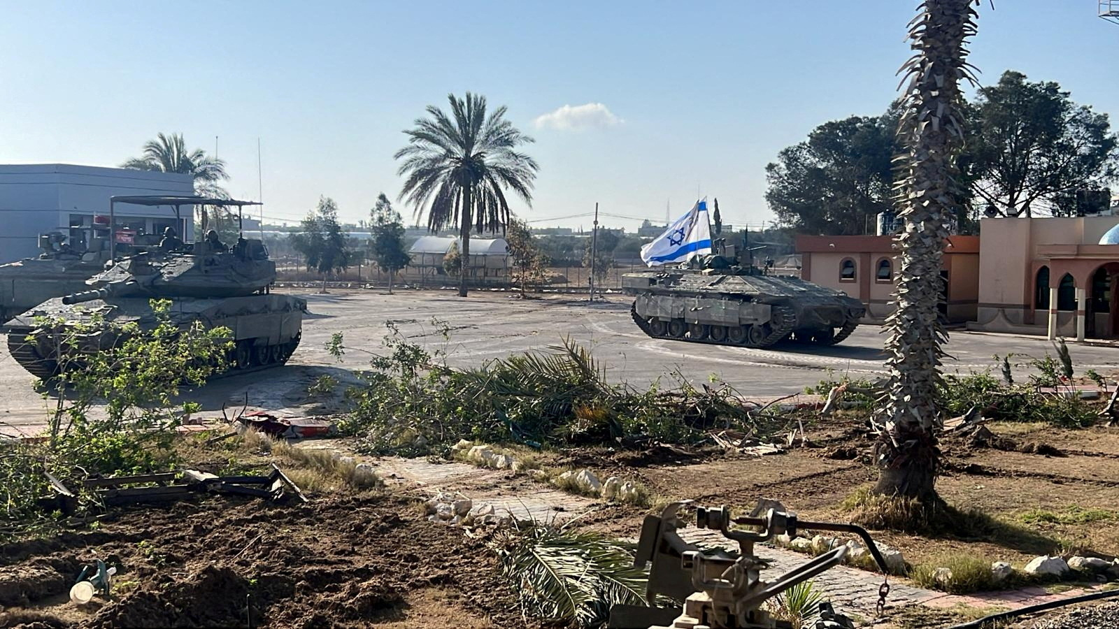 Israeli military vehicles operate in the Gazan side of the Rafah Crossing, amid the ongoing conflict between Israel and Palestinian Islamist group Hamas, in the southern Gaza Strip, in this handout image released on May 7, 2024