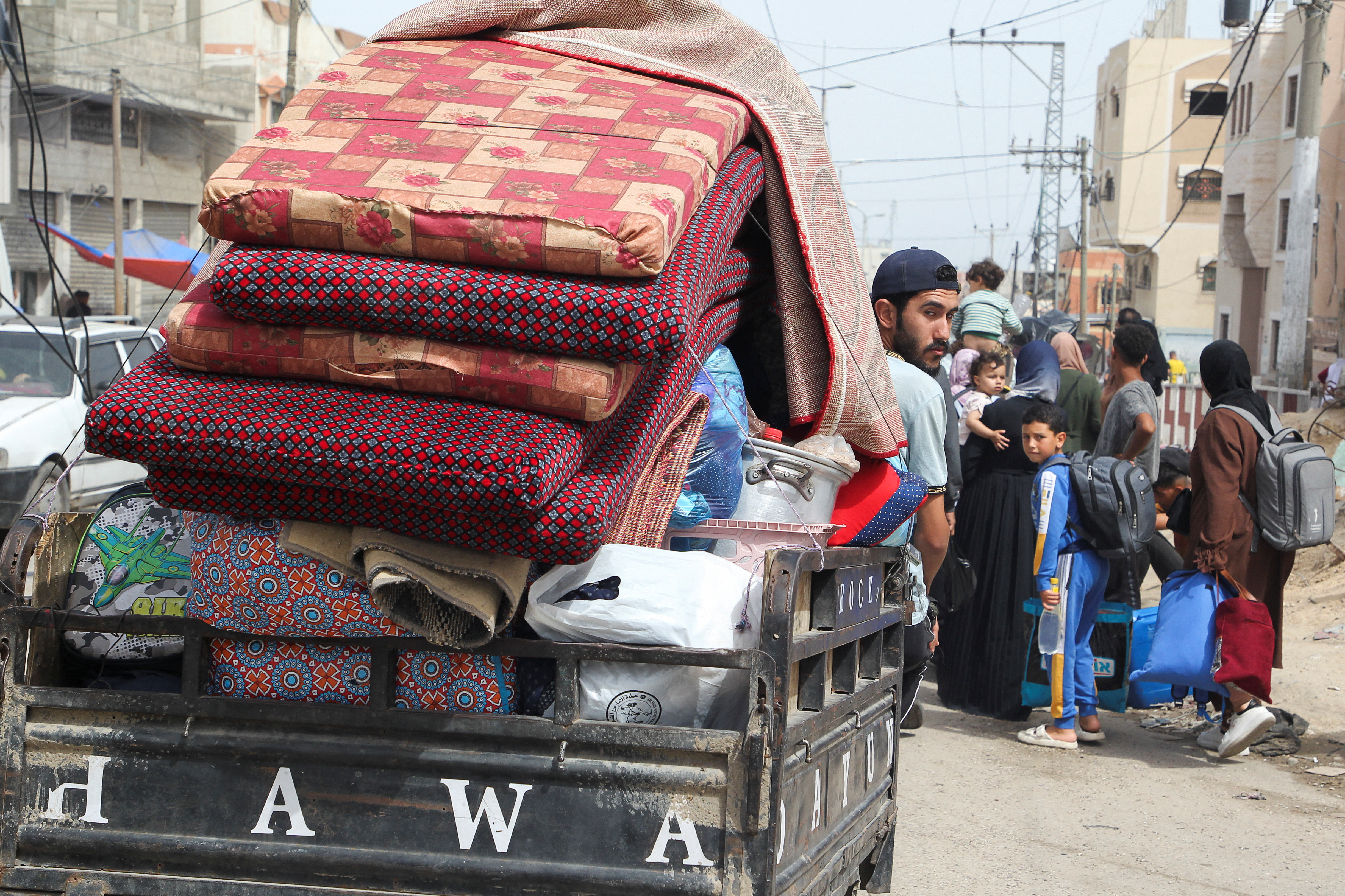 A man looks from a vehicle loaded with belongings, as Palestinians prepare to evacuate, after Israeli forces launched a ground and air operation in the eastern part of Rafah