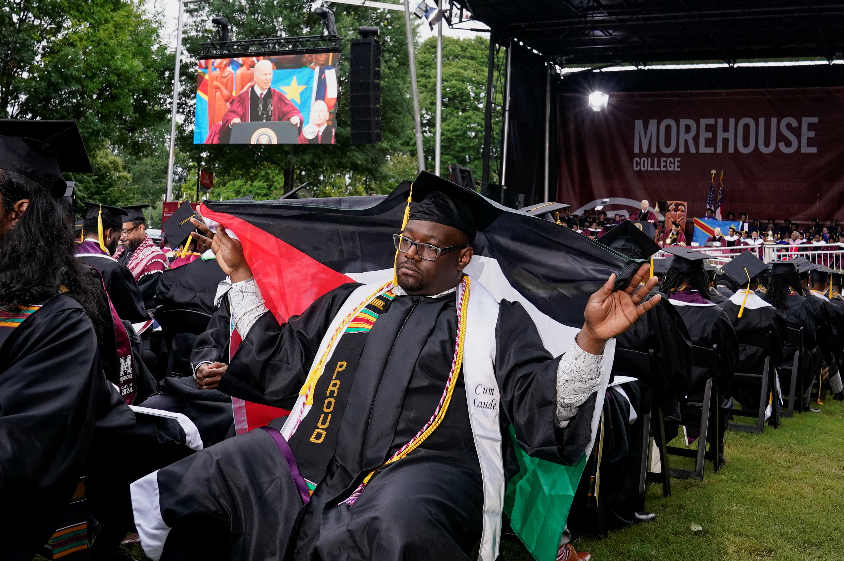 A Morehouse College graduate holds a Palestinian flag during Biden's speech