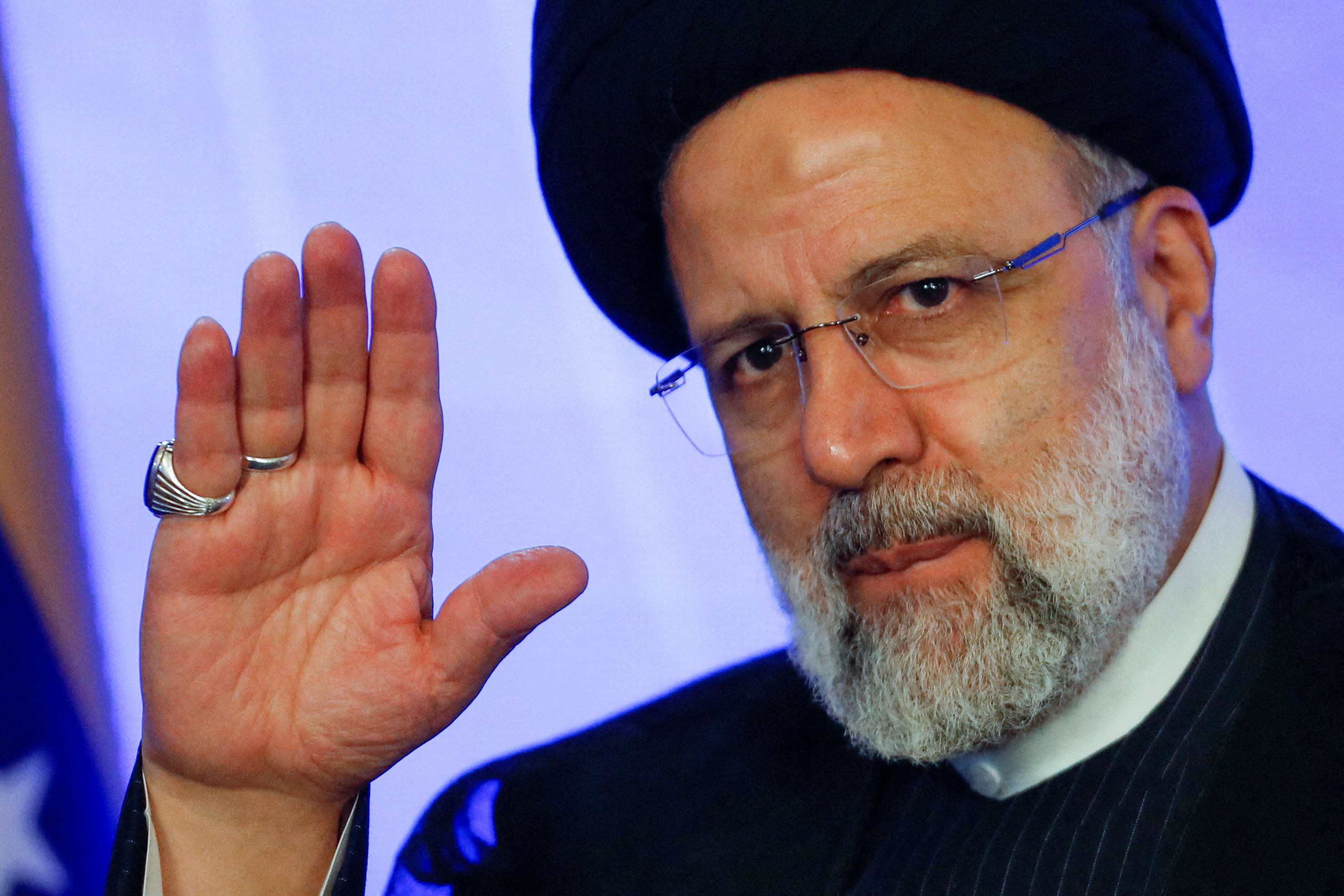 Iranian President Ebrahim Raisi gestures