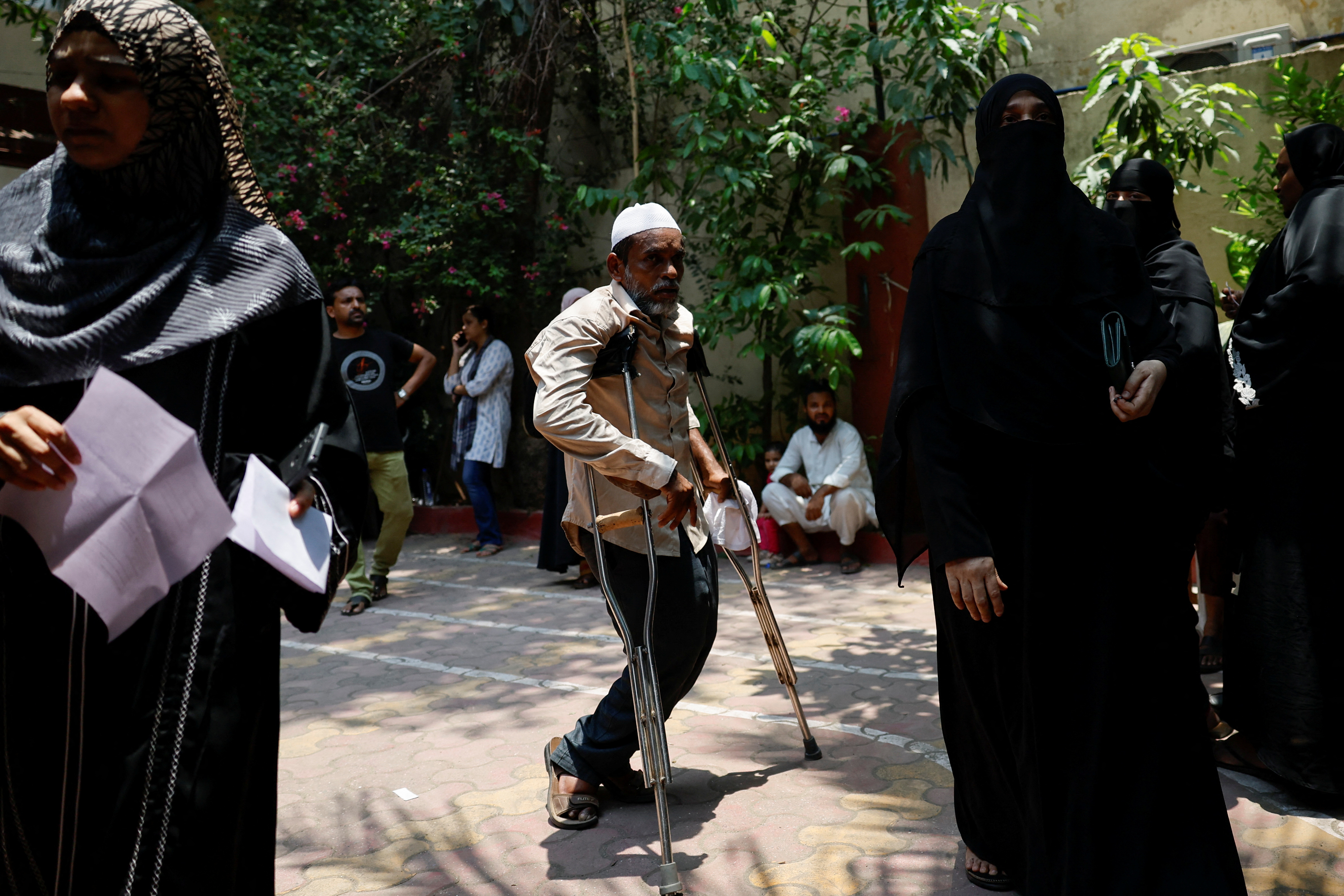 A man using crutches arrives at a polling station during the fifth phase of India's general election, in Mumbra, on the outskirts of Mumbai, India, May 20, 2024.