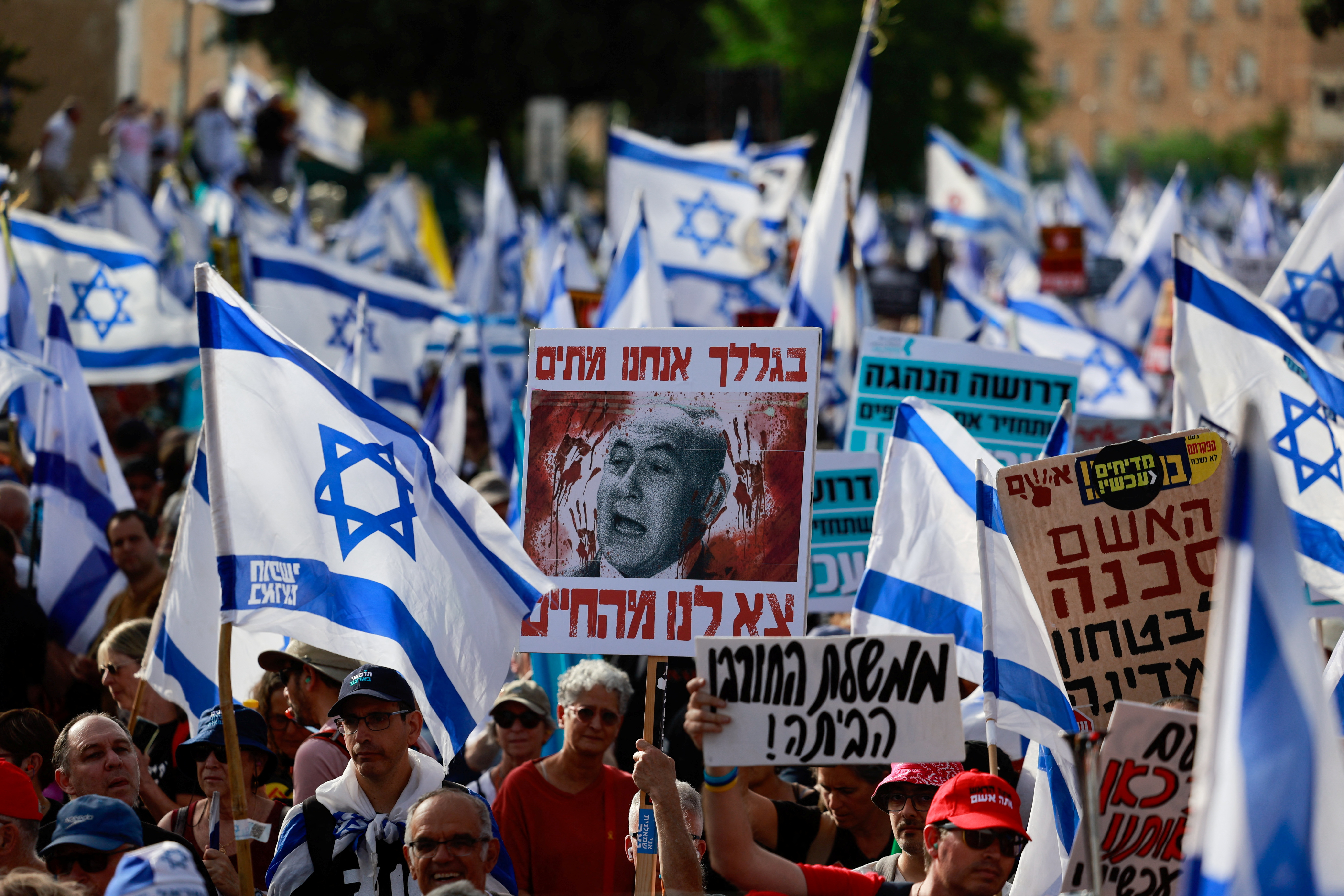 Supporters of bereaved family members and the families of hostages who were kidnapped during the deadly October 7 attack by Palestinian Islamist group Hamas, protest on a Day of Disruption by anti-government protest groups, amid the ongoing conflict in Gaza between Israel and Hamas in Gaza, outside the Knesset, Israel's Parliament in Jerusalem, May 20, 2024. REUTERS/Ammar Awad