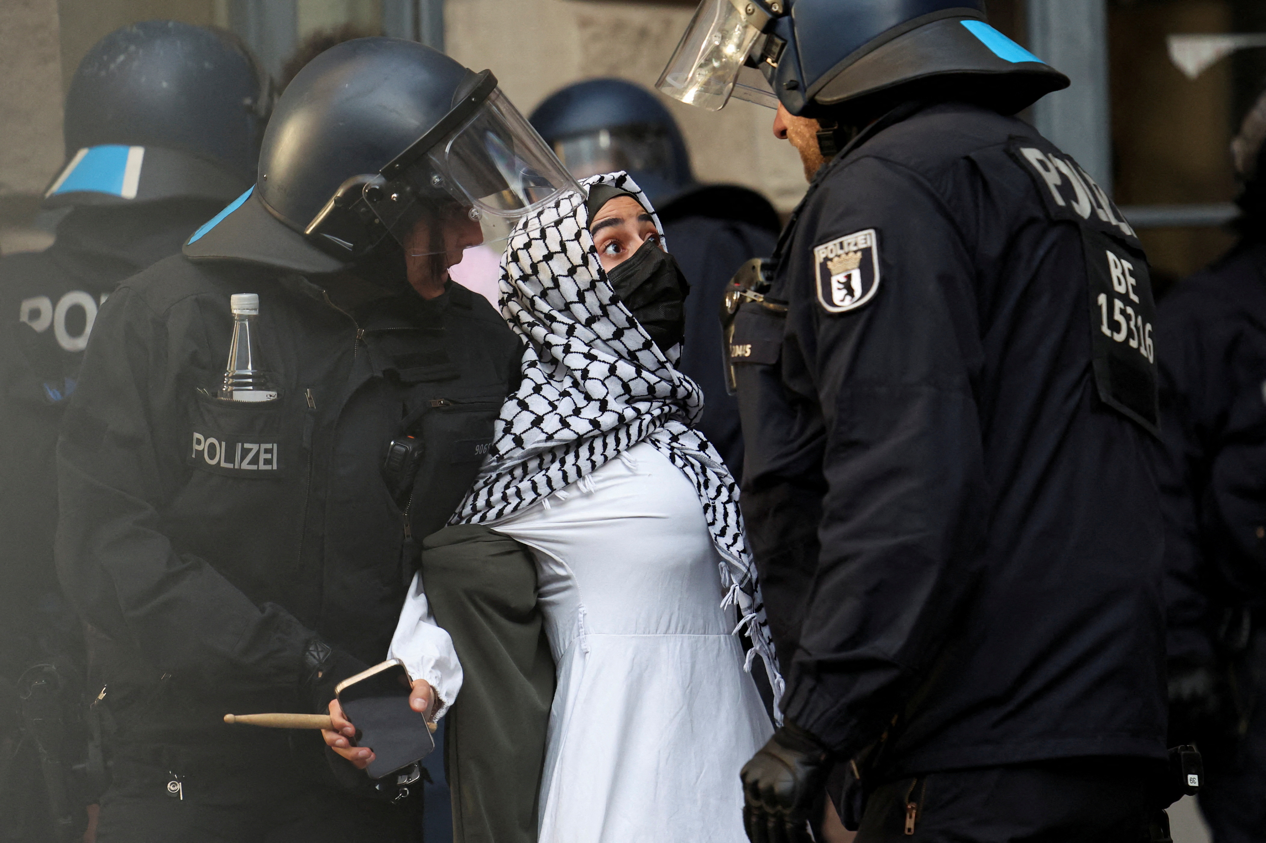 Police officers remove a pro-Palestinian demonstrator, as demonstrators occupy a building at the Humboldt University, amid the ongoing conflict between Israel and Palestinian Islamist group Hamas, in Berlin, Germany, May 23