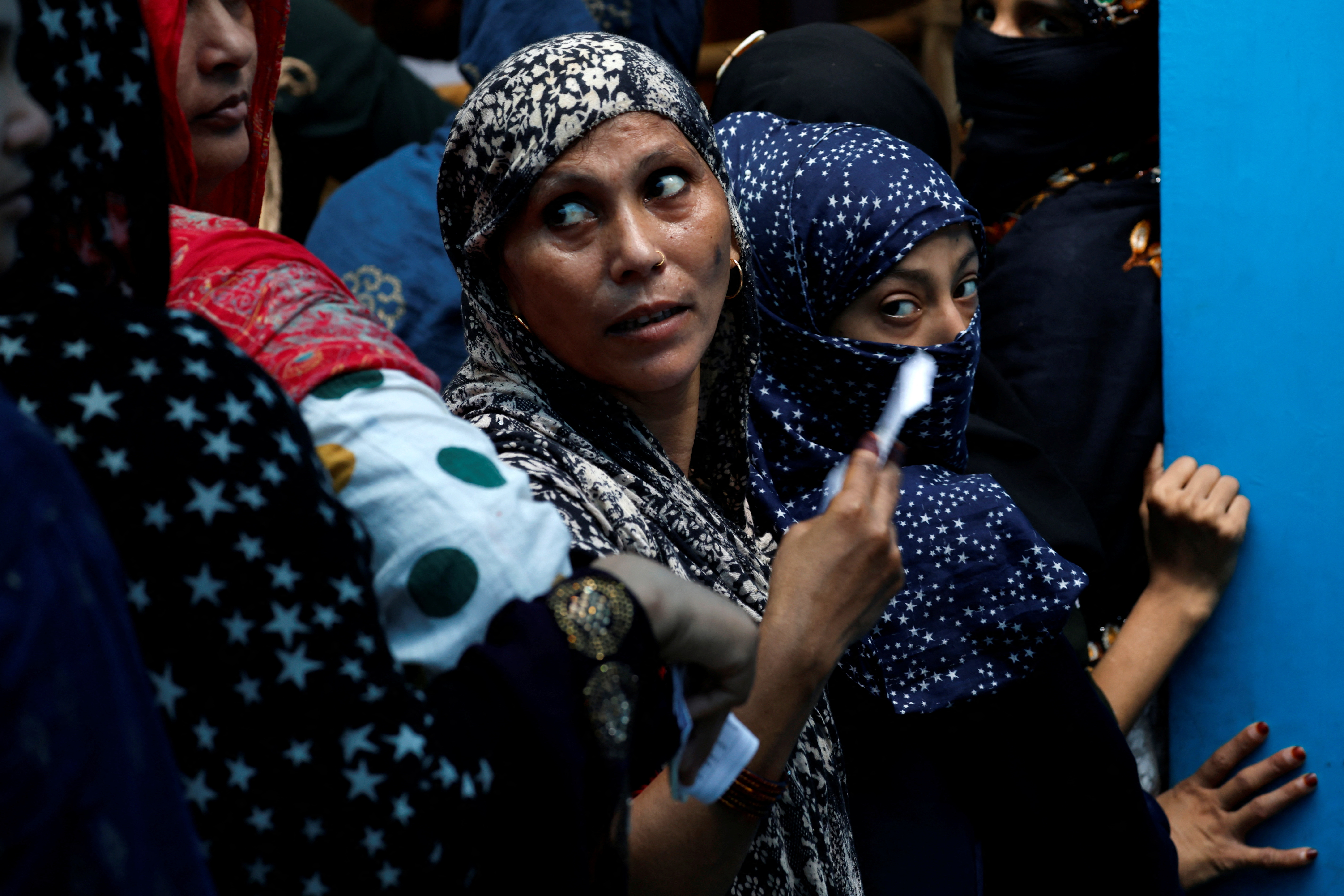 Women wait in a line to cast their votes at a polling station during the sixth phase of India’s general election in Jafrabad area of Delhi, India, May 25, 2024.