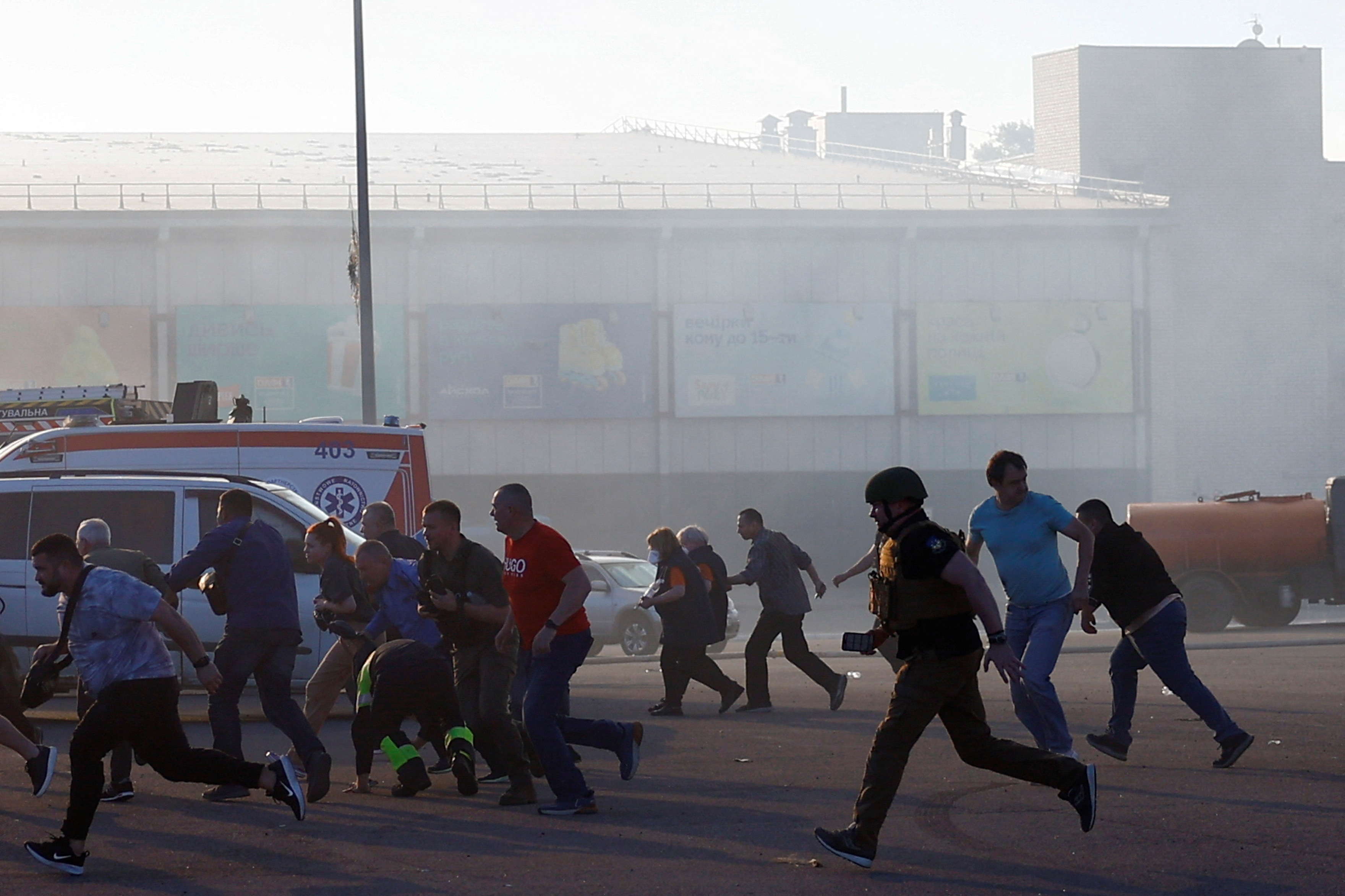 People run, after the announcement of a Russian missile attack towards Kharkiv, at the site of a household item shopping mall which was hit by a Russian air strike, amid Russia's attack on Ukraine, in Kharkiv, Ukraine, May 25, 2024. REUTERS/Valentyn Ogirenko