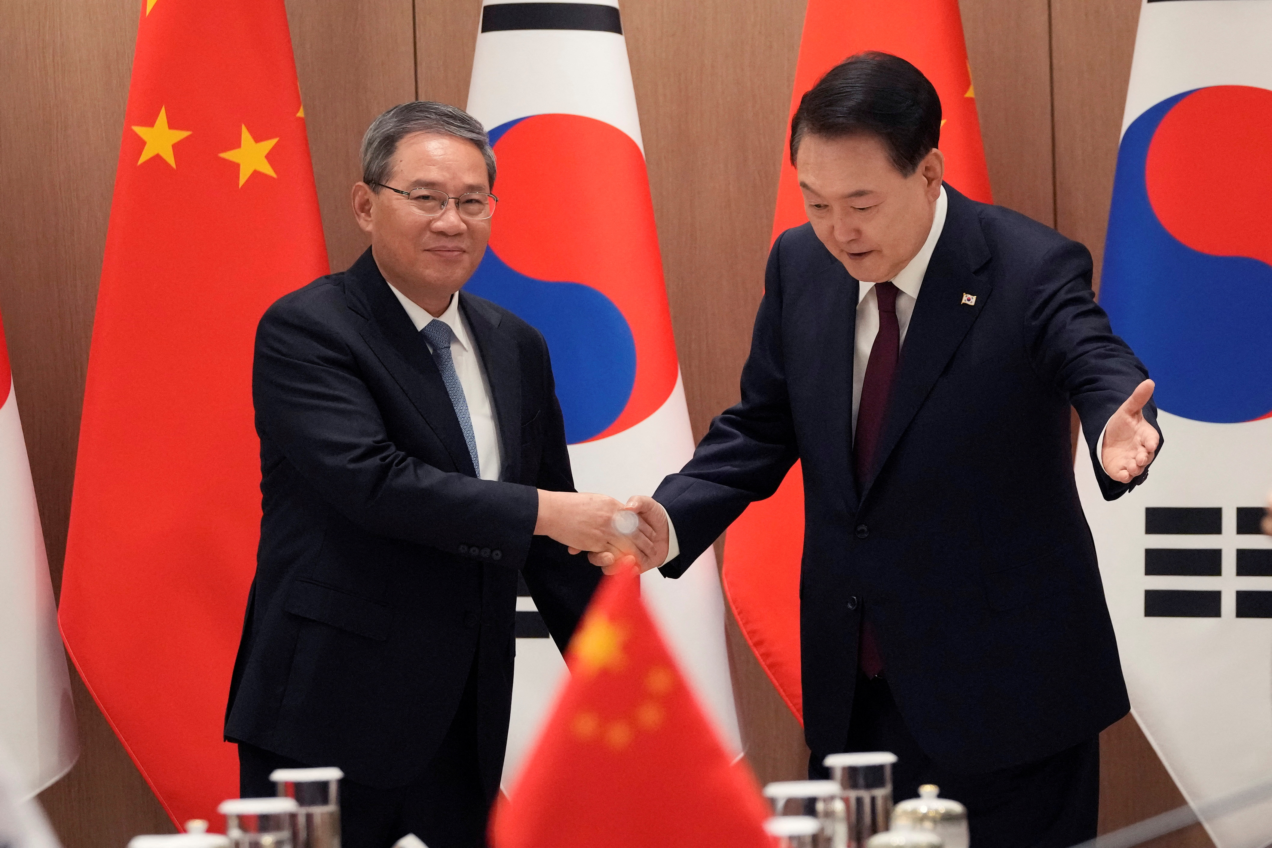 South Korean President Yoon Suk Yeol greets Chinese Premier Li Qiang