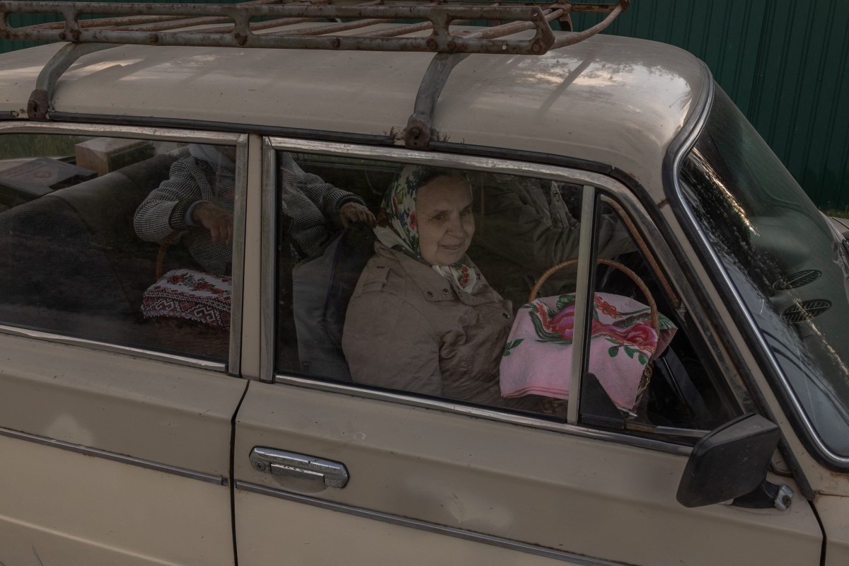Orthodox devotees sit in a car with baskets of traditional Easter delights after being blessed by a Ukrainian priest on Orthodox Easter in the village of Krasne, Chernigiv region