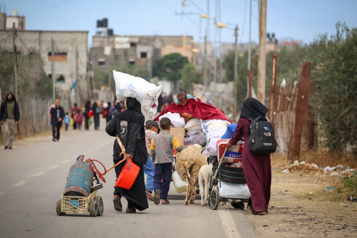 Displaced Palestinians in Rafah in the southern Gaza Strip carry their belongings as they leave following an evacuation order by the Israeli army on May 6, 2024, amid the ongoing conflict between Israel and the Palestinian Hamas movement