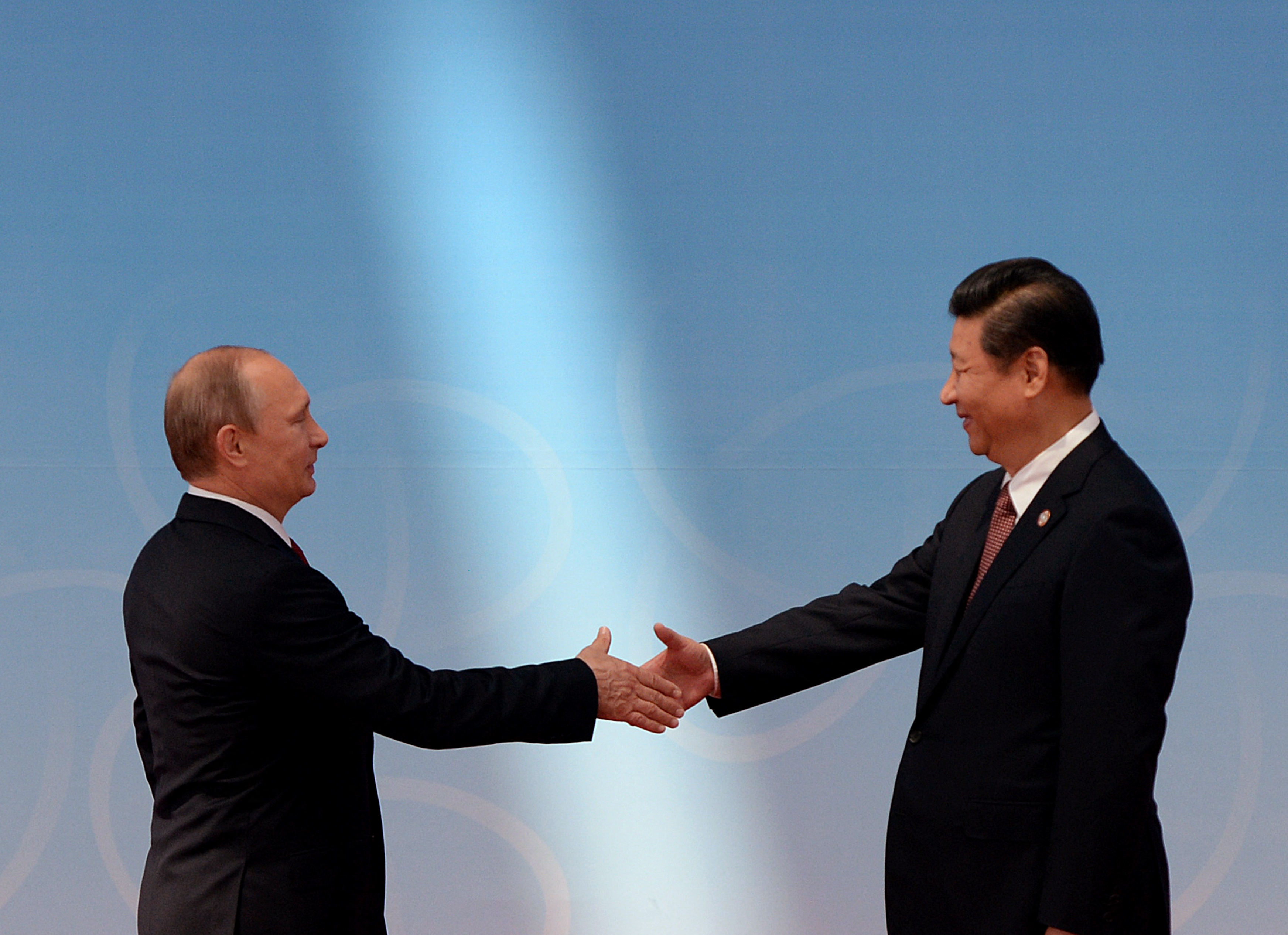 (FILES) Russia's President Vladimir Putin is greeted by China's President Xi Jinping [File: Mark Ralston/AFP]