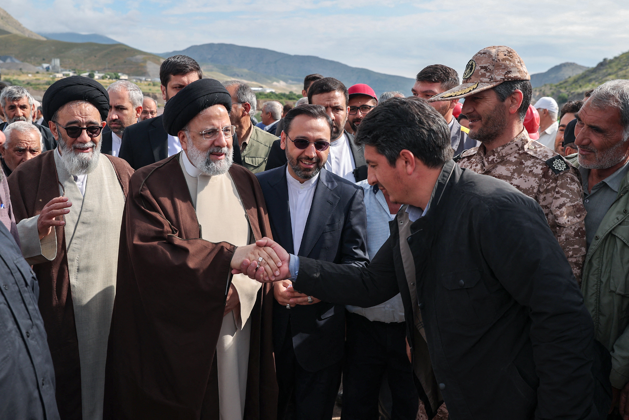 Iran's President Ebrahim Raisi, second from left, with his delegation in Aras, ahead of the inauguration of a dam project on the border with Azerbaijan on May 19, 2024 [Iranian Presidency/AFP]