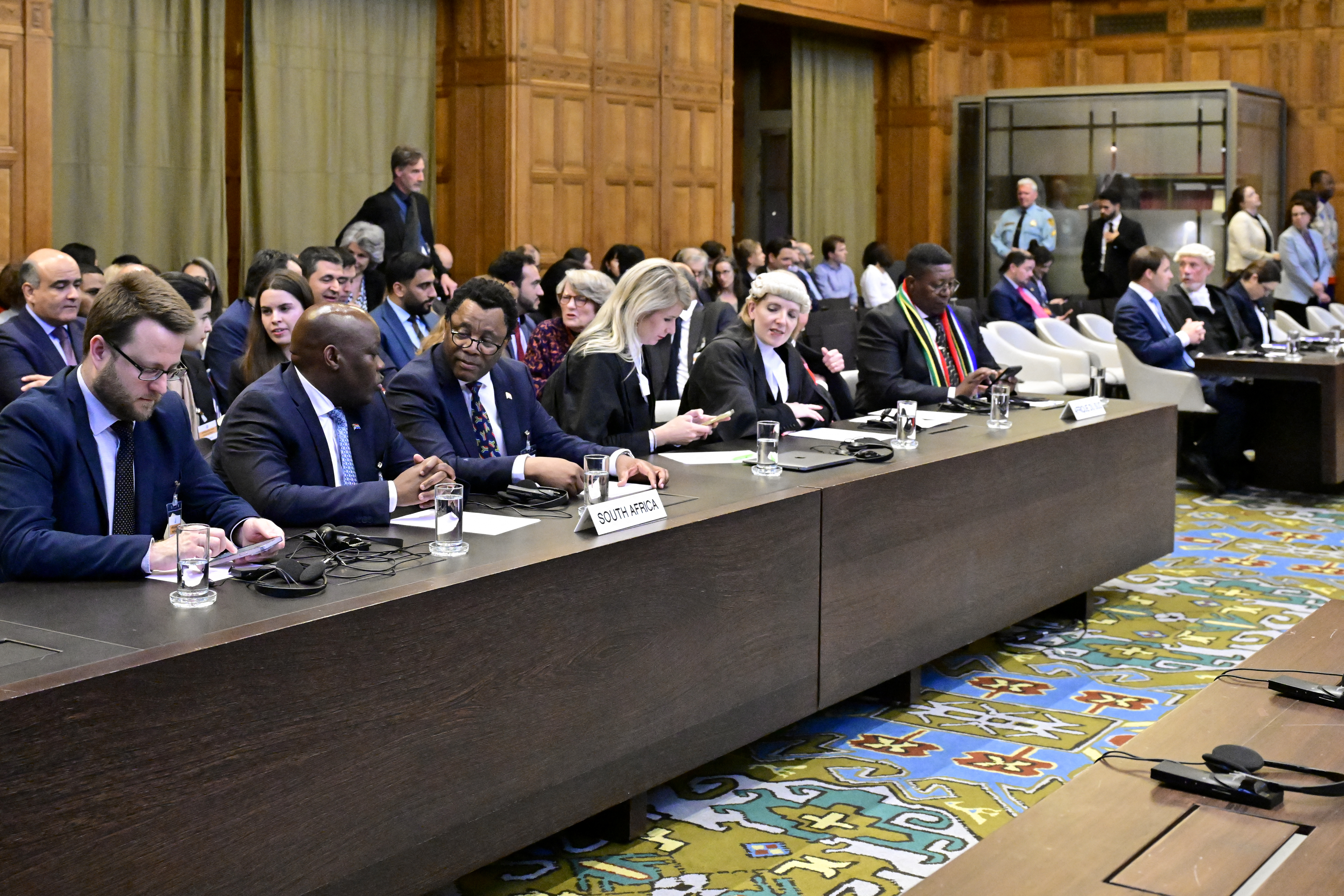 Members of the South Africa's legal team (L) attend a hearing at the International Court of Justice (ICJ) as part of South Africa's request on a Gaza ceasefire in The Hague