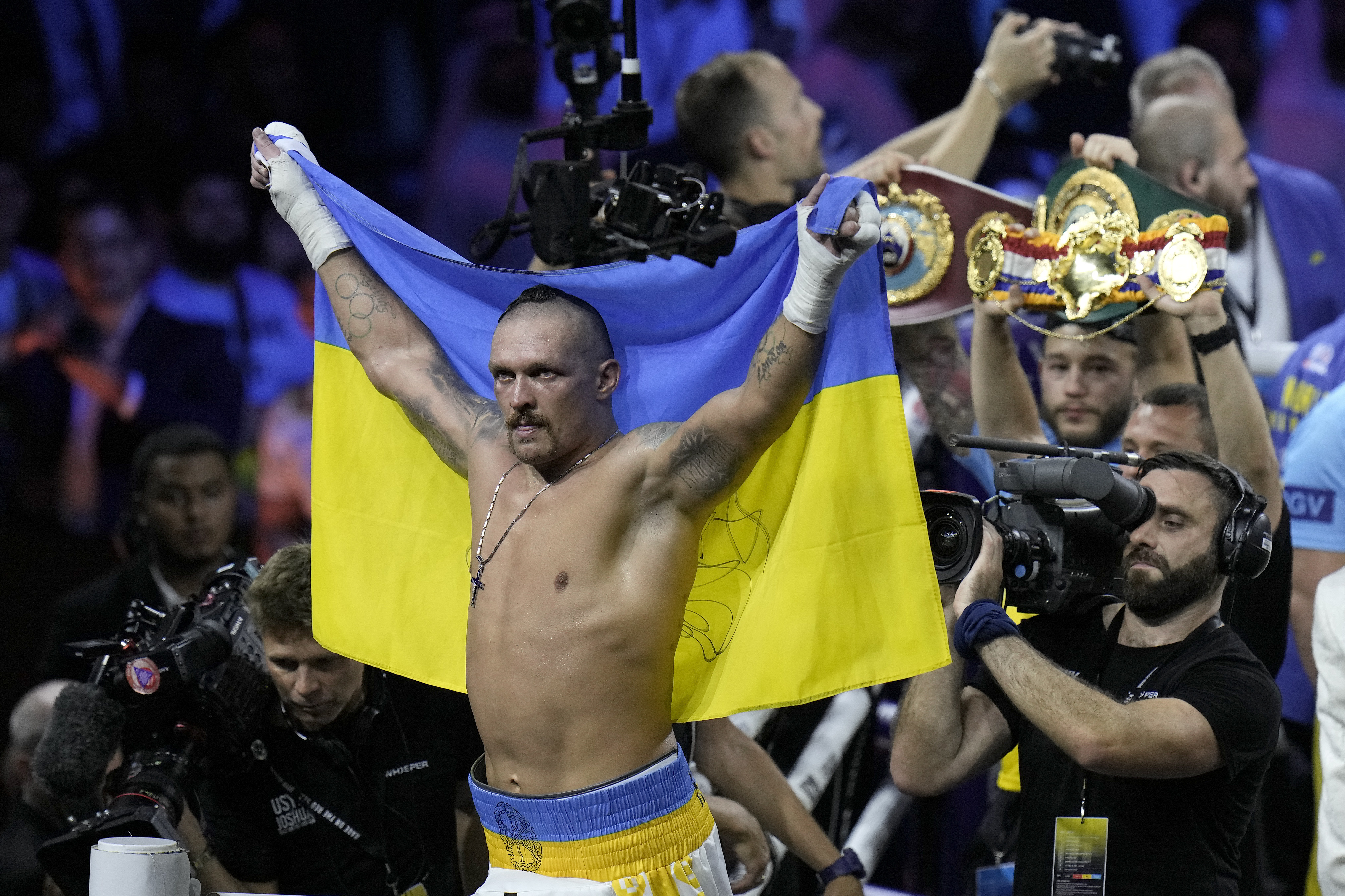 FILE - Ukraine's Oleksandr Usyk celebrates after beating Britain's Anthony Joshua to retain his world heavyweight title at King Abdullah Sports City in Jeddah, Saudi Arabia, Sunday, Aug. 21, 2022. Heavyweight champion Oleksandr Usyk is set to defend his WBA, WBO and IBF belts against Daniel Dubois this August in Poland, where the Ukrainian fighter will have plenty of home support. Usyk announced Thursday, July 6, 2023, that he’ll face Dubois, a Briton who is the WBA mandatory challenger, on Aug. 26 at Tarczynski Arena. (AP Photo/Hassan Ammar, File)