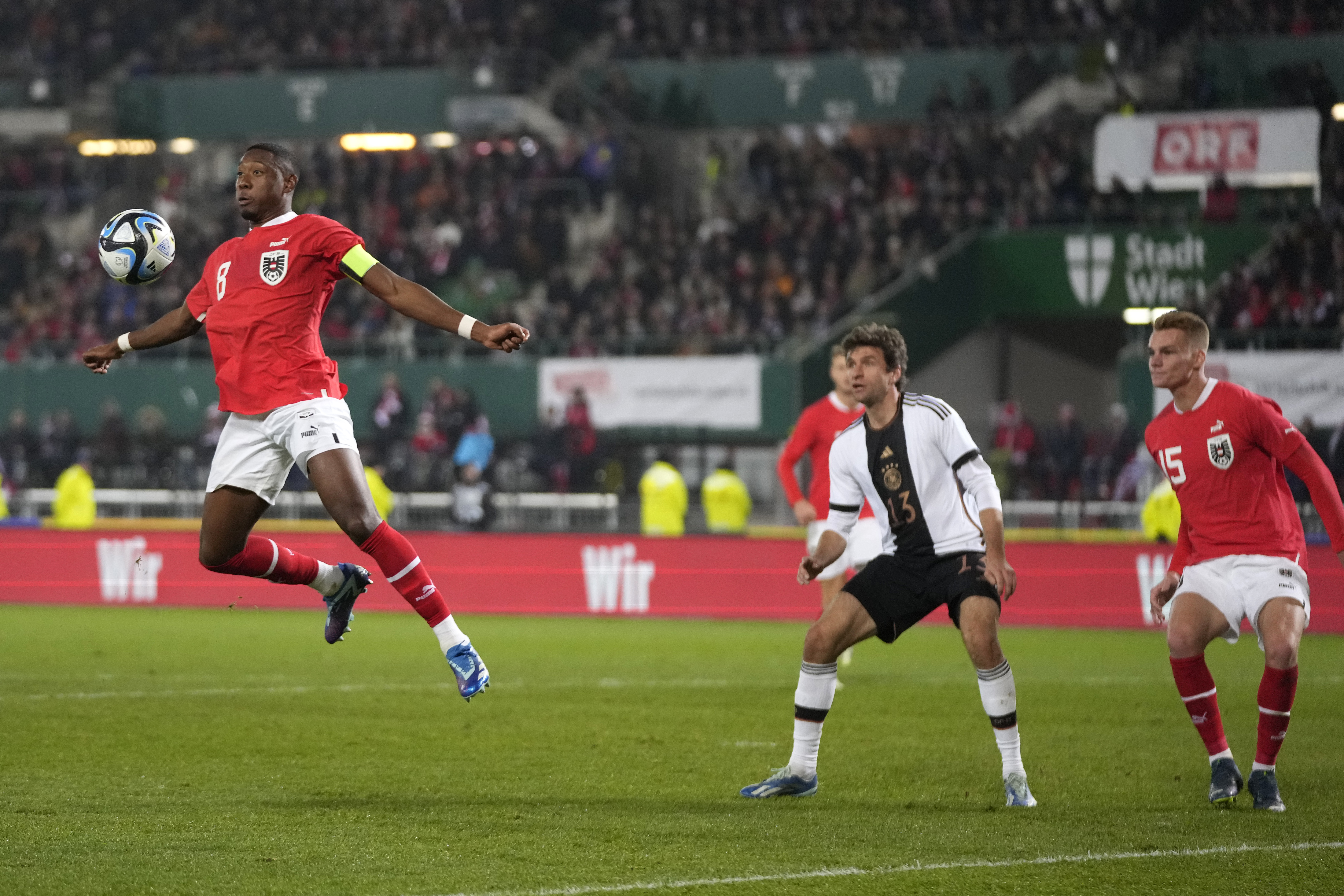 Player rises to head a football towards goal.