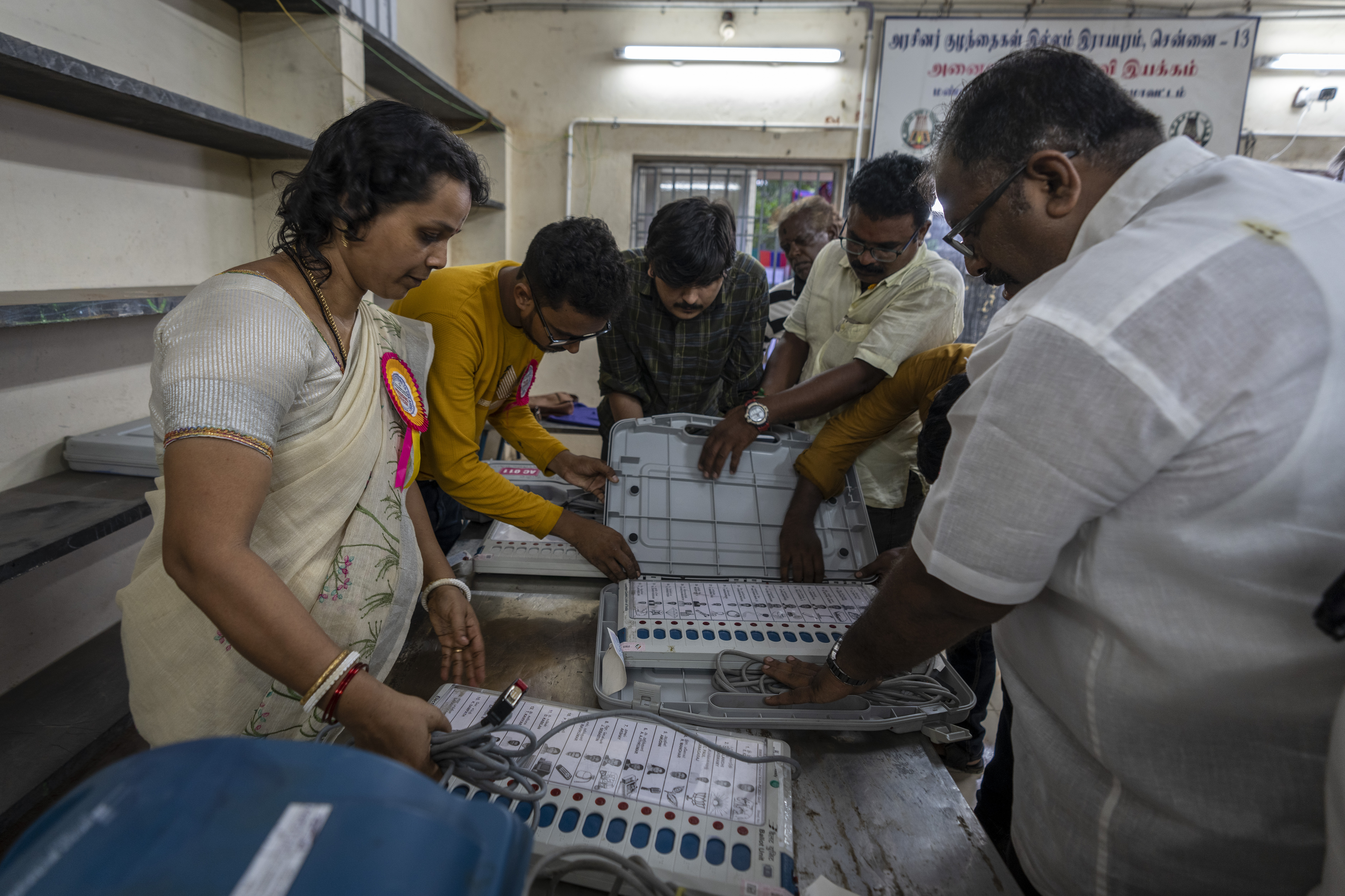 Election officials prepare to seal the Electronic Voting Machines (EVMs) as the voting ends at a polling station in Chennai, southern Tamil Nadu state, Friday, April 19, 2024. Nearly 970 million voters will elect 543 members for the lower house of Parliament for five years, during staggered elections that will run until June 1. (AP Photo/Altaf Qadri)