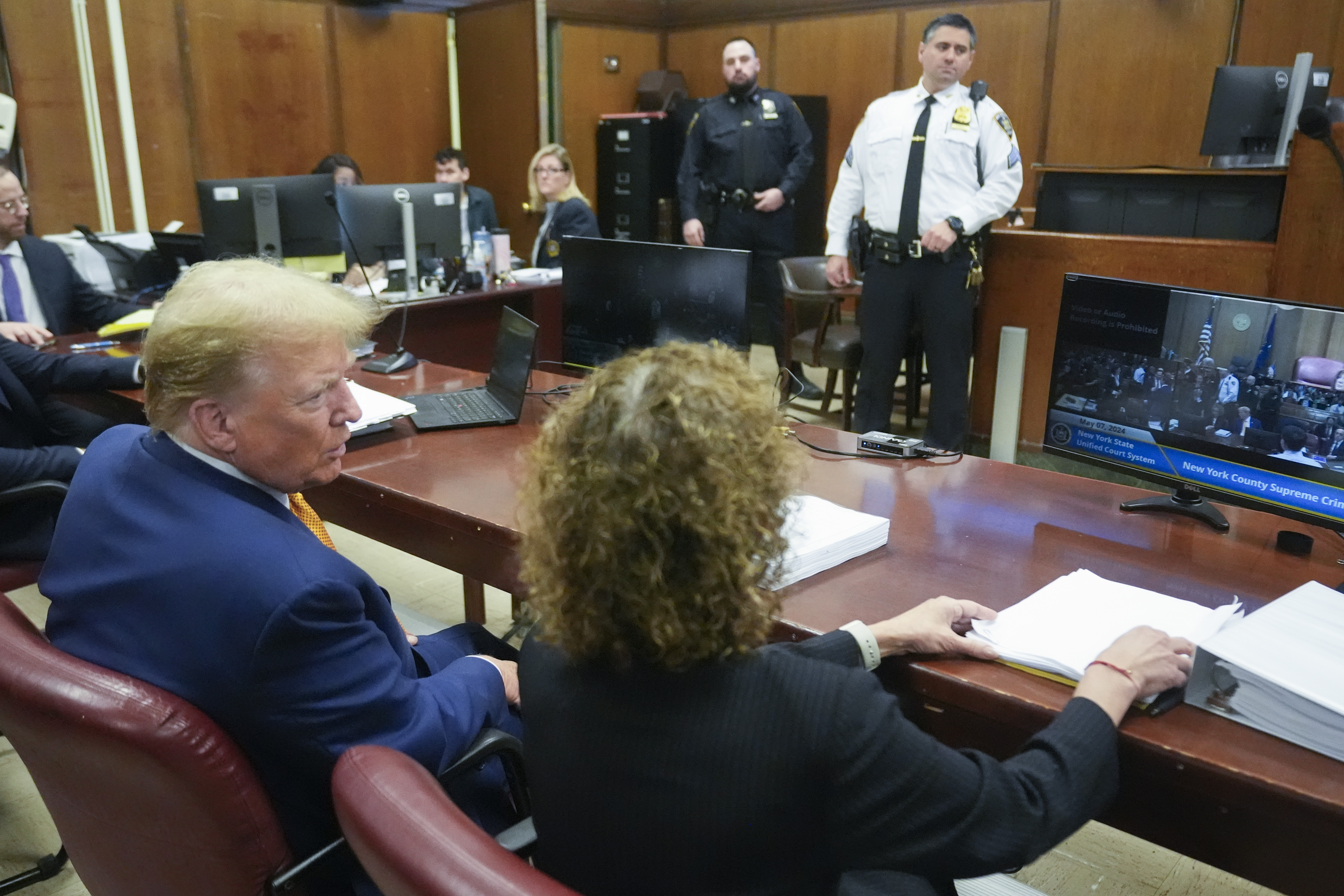 Donald Trump is seen from behind sitting with lawyer Susan Necheles at his New York criminal trial.