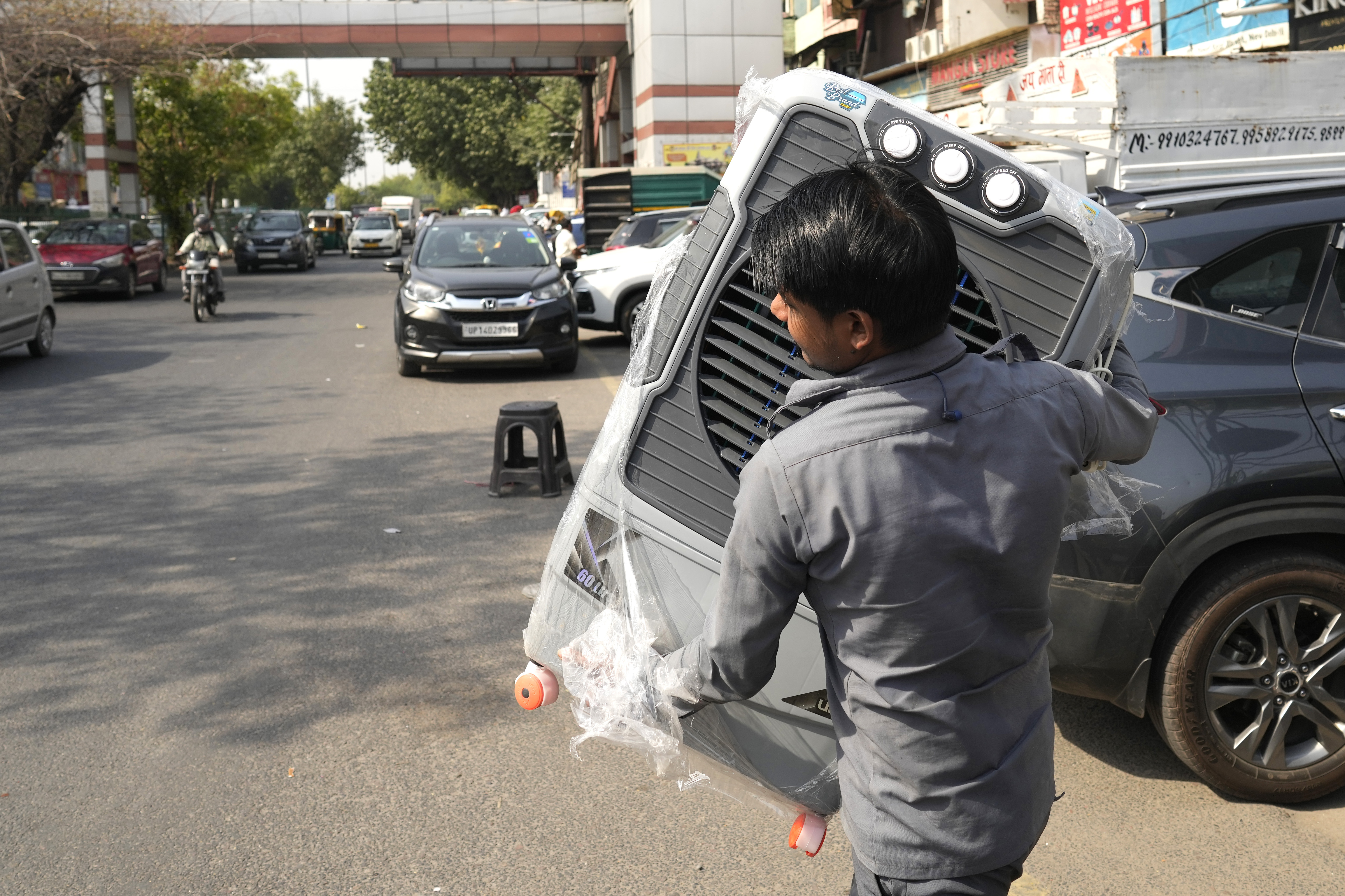 A man carries a water cooler for his home