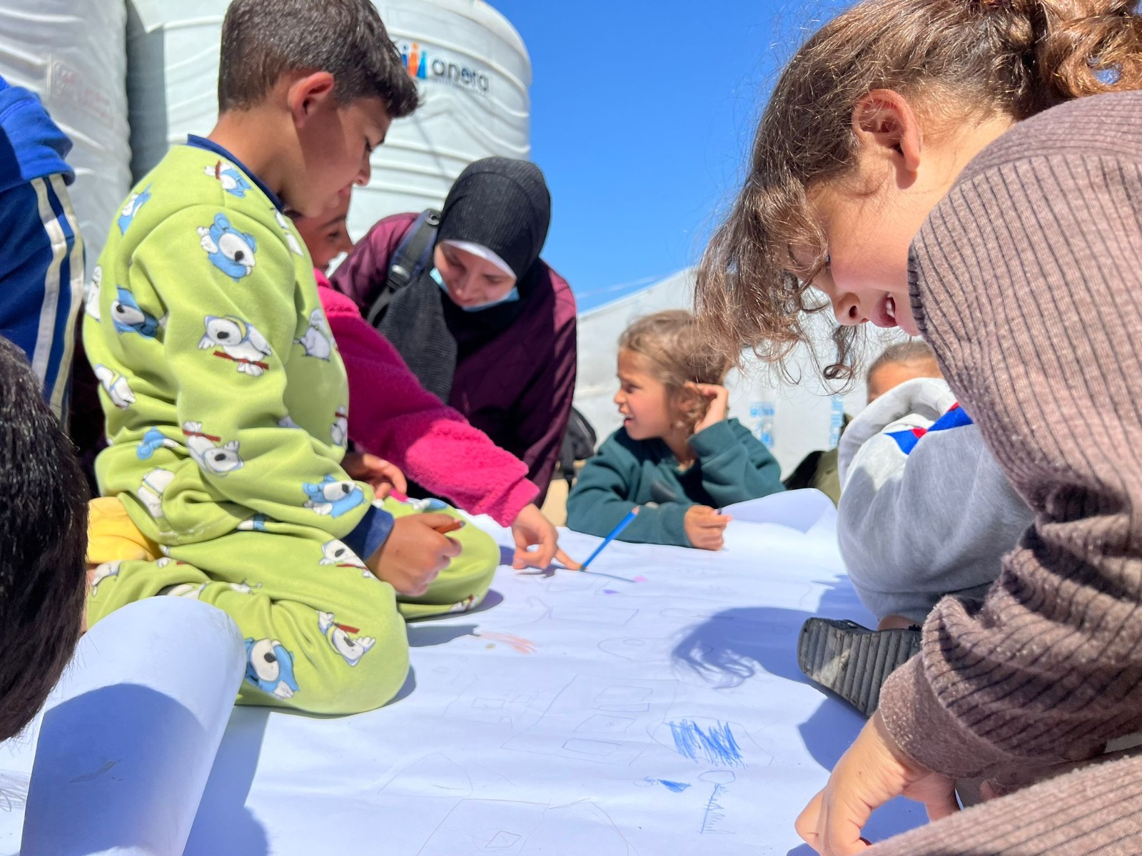 Children enjoy a brief respite from war when they take part in an art workshop in Rafah but “only an immediate and permanent ceasefire will deliver children from the hell on earth they are living through,” says William Bell, from Christian Aid which is funding the activity.