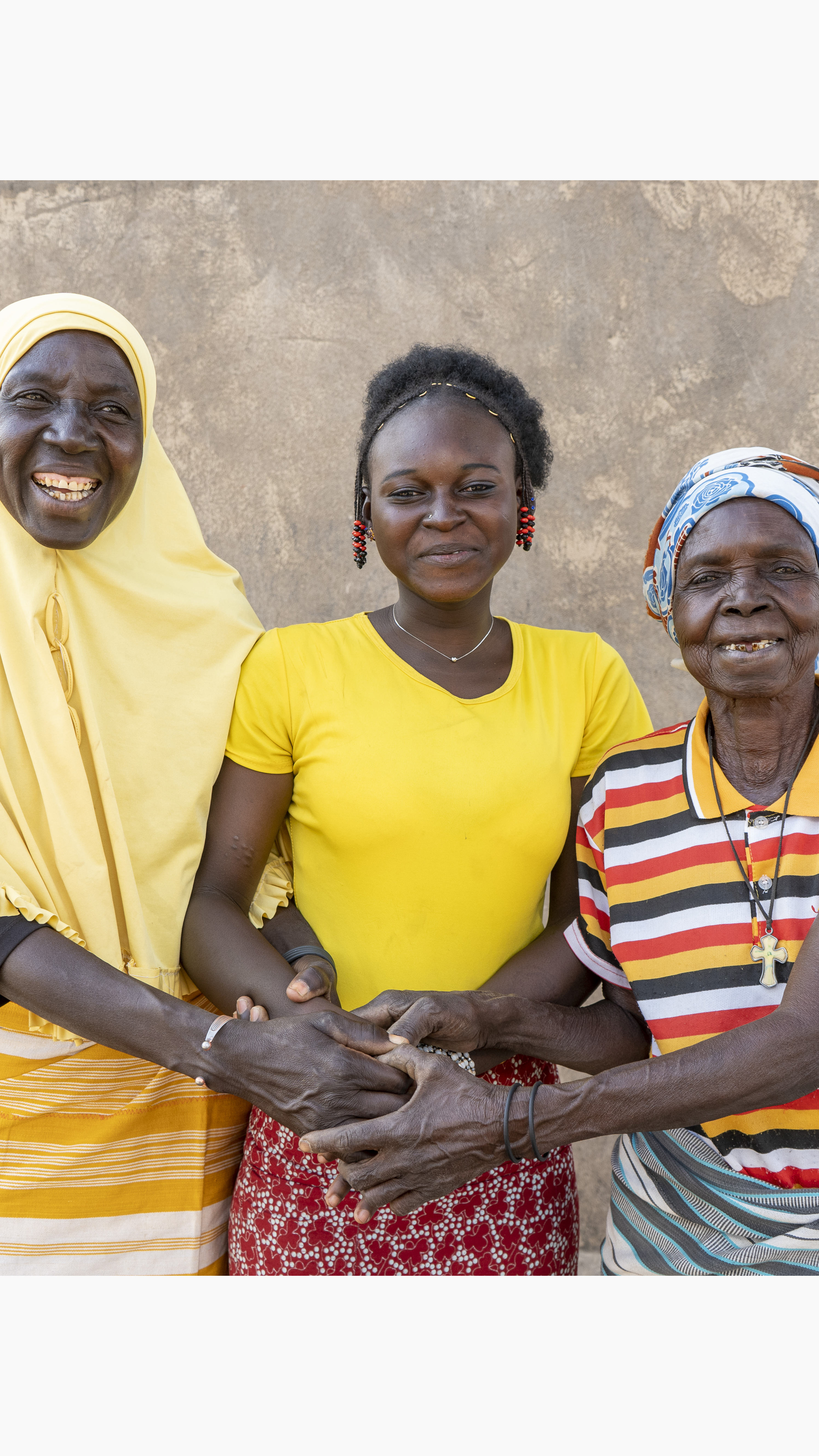 Burkinabé grandmother Marie, 76, with her daughter, Aminata, 60, and teenage granddaughter, Nassiratou, 18 — known affectionately as Nassi — at home in west-central Burkina Faso [Isso EmmanuelBationo/Plan International]