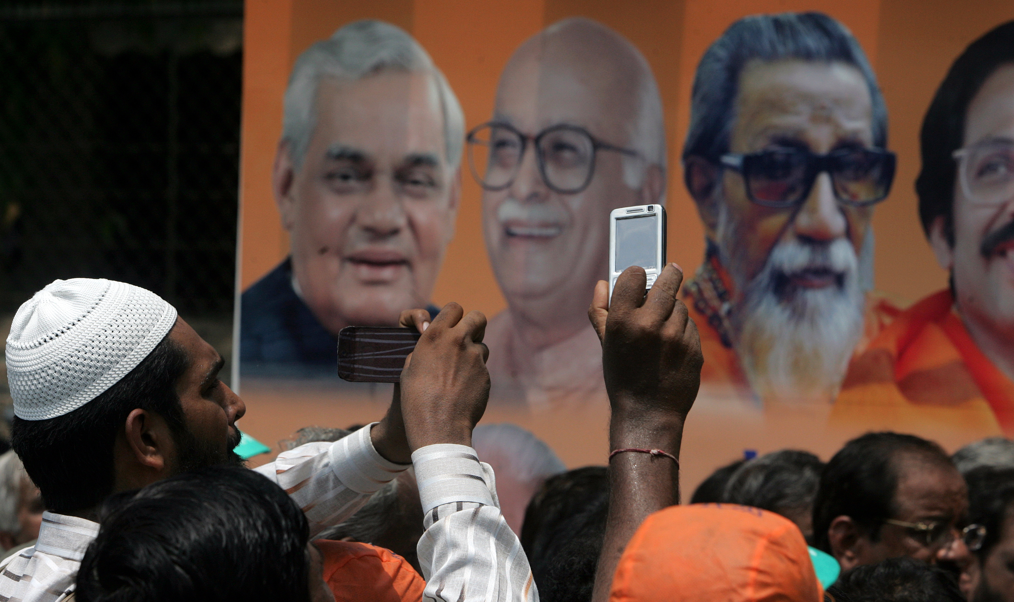 Supporters of BJP candidate from North Mumbai Mr. Ram Naik takes pictures of his Rath outside Bandra Collector's office where he filed his nomination form for Loksabha elections on Thursday.