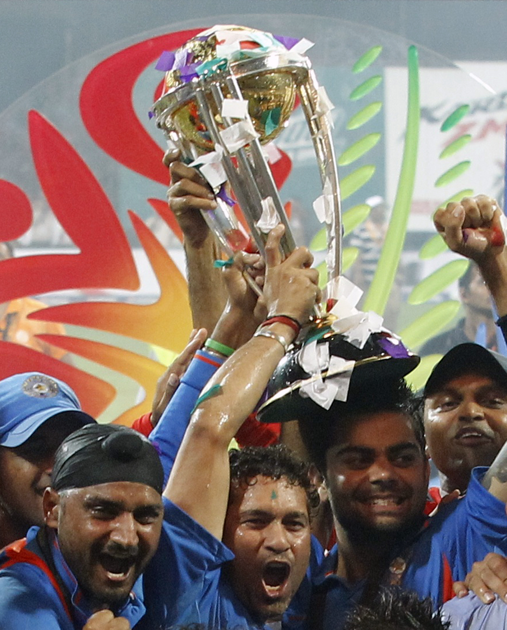 India's Harbhajan Singh (2nd L), Sachin Tendulkar (C) and Virat Kohli (2nd R) hold the ICC Cricket World Cup trophy 2011 after they beat Sri Lanka in the ICC Cricket World Cup final match in Mumbai April 2, 2011. REUTERS/Vivek Prakash (INDIA - Tags: SPORT CRICKET)