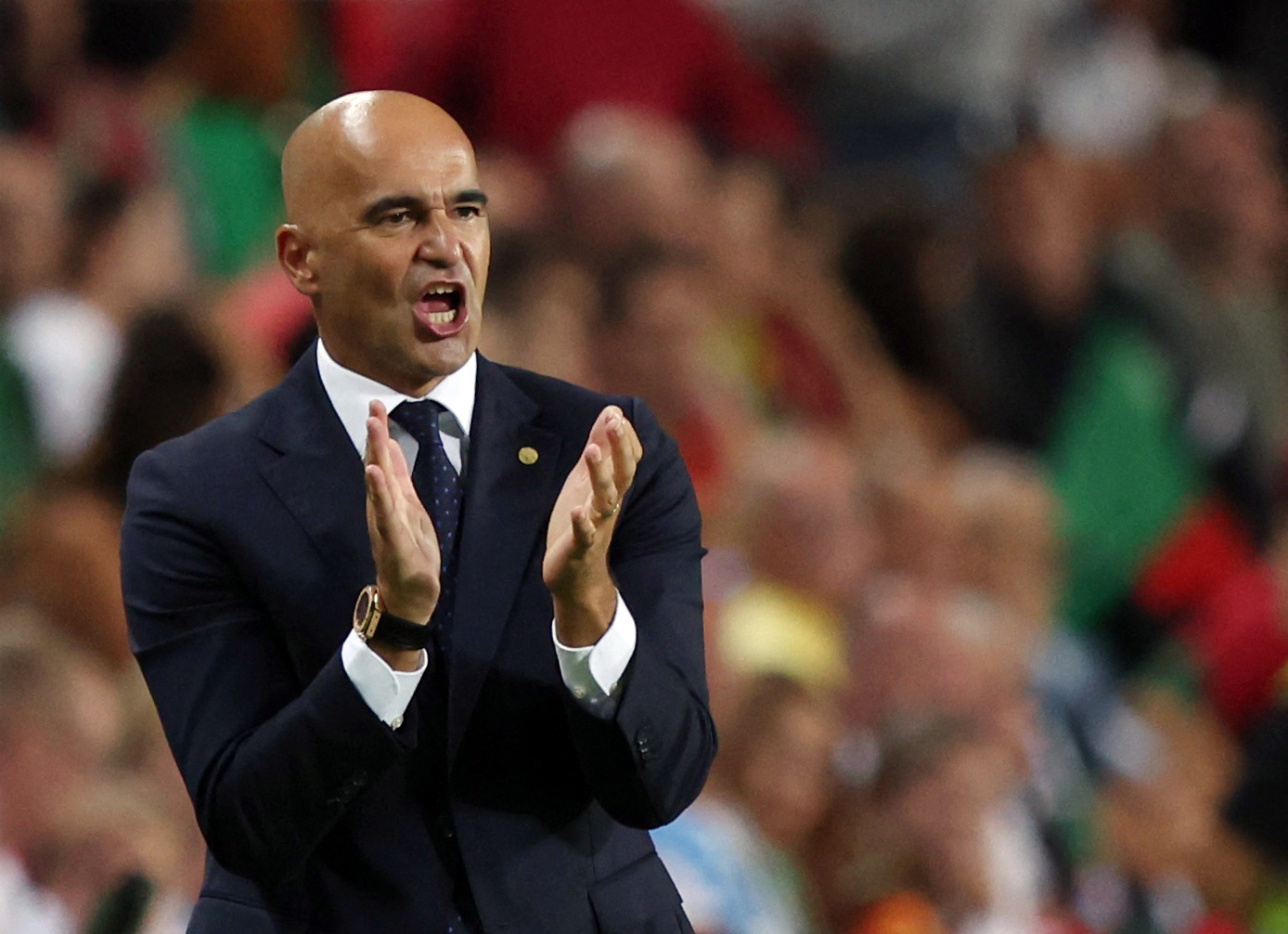 Football coach encourages players.