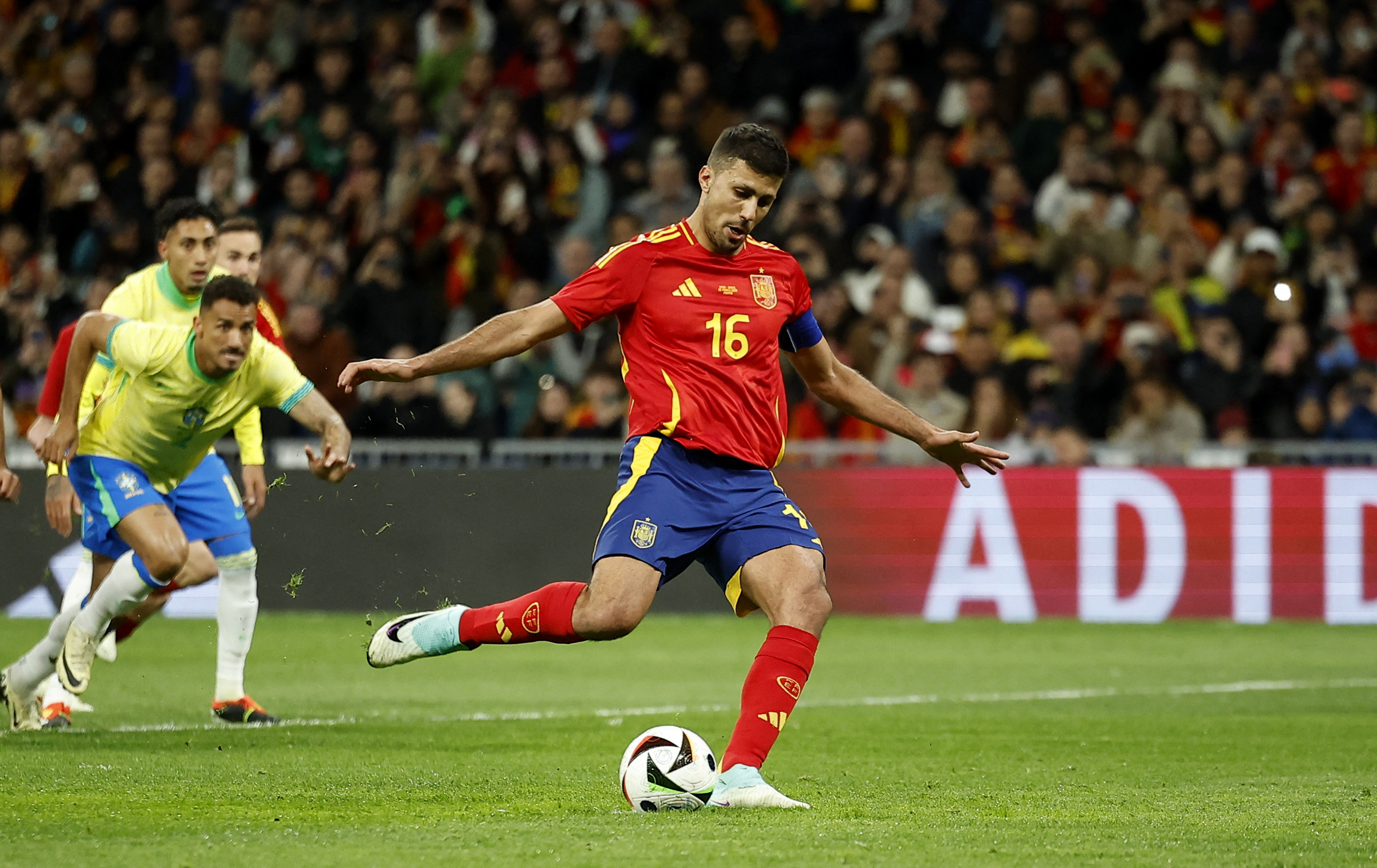 Football player strikes ball during a match.
