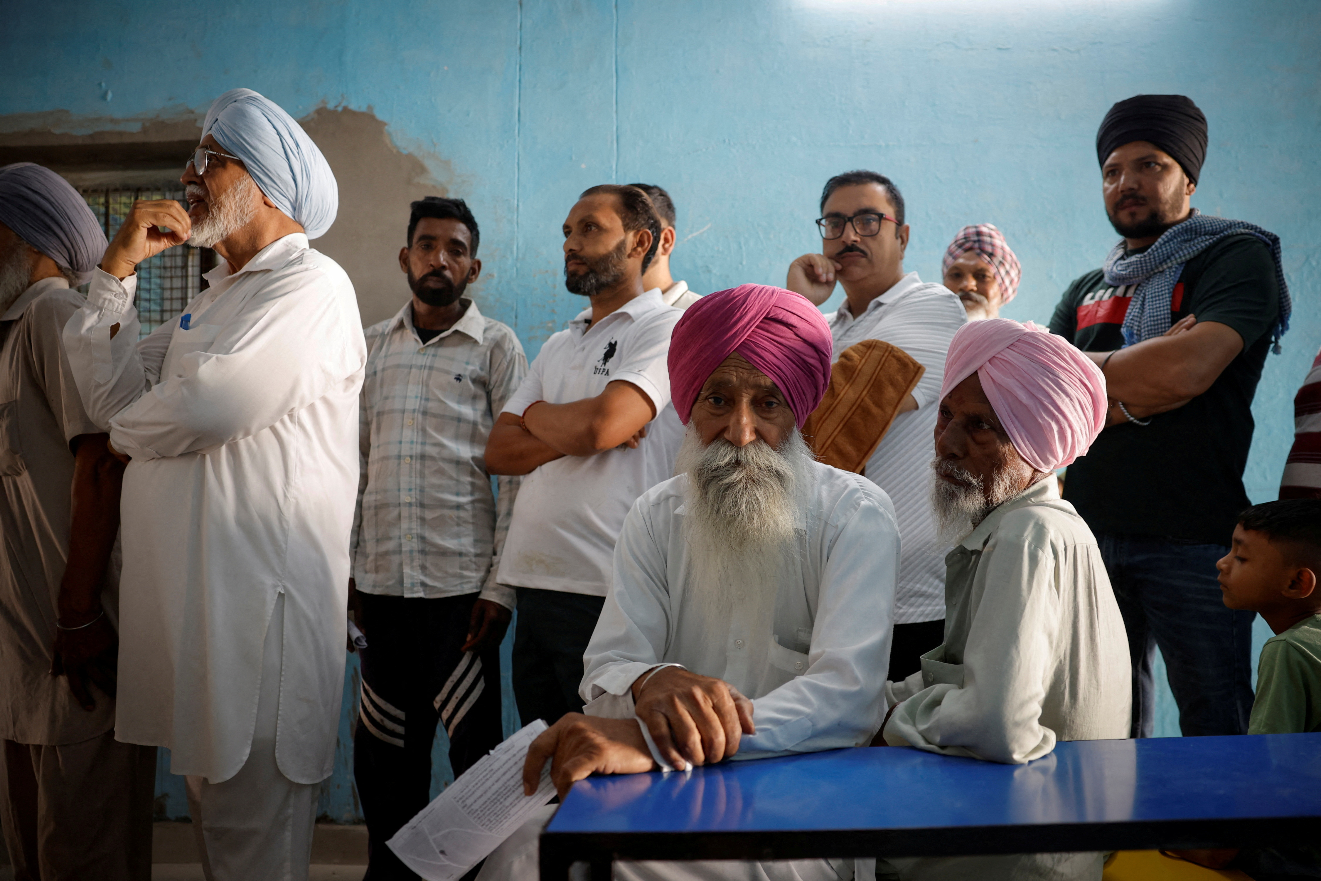 Voters wait to cast their votes at a polling station during the seventh and last phase of the general election, in Faridkot district, Punjab, India, June 1