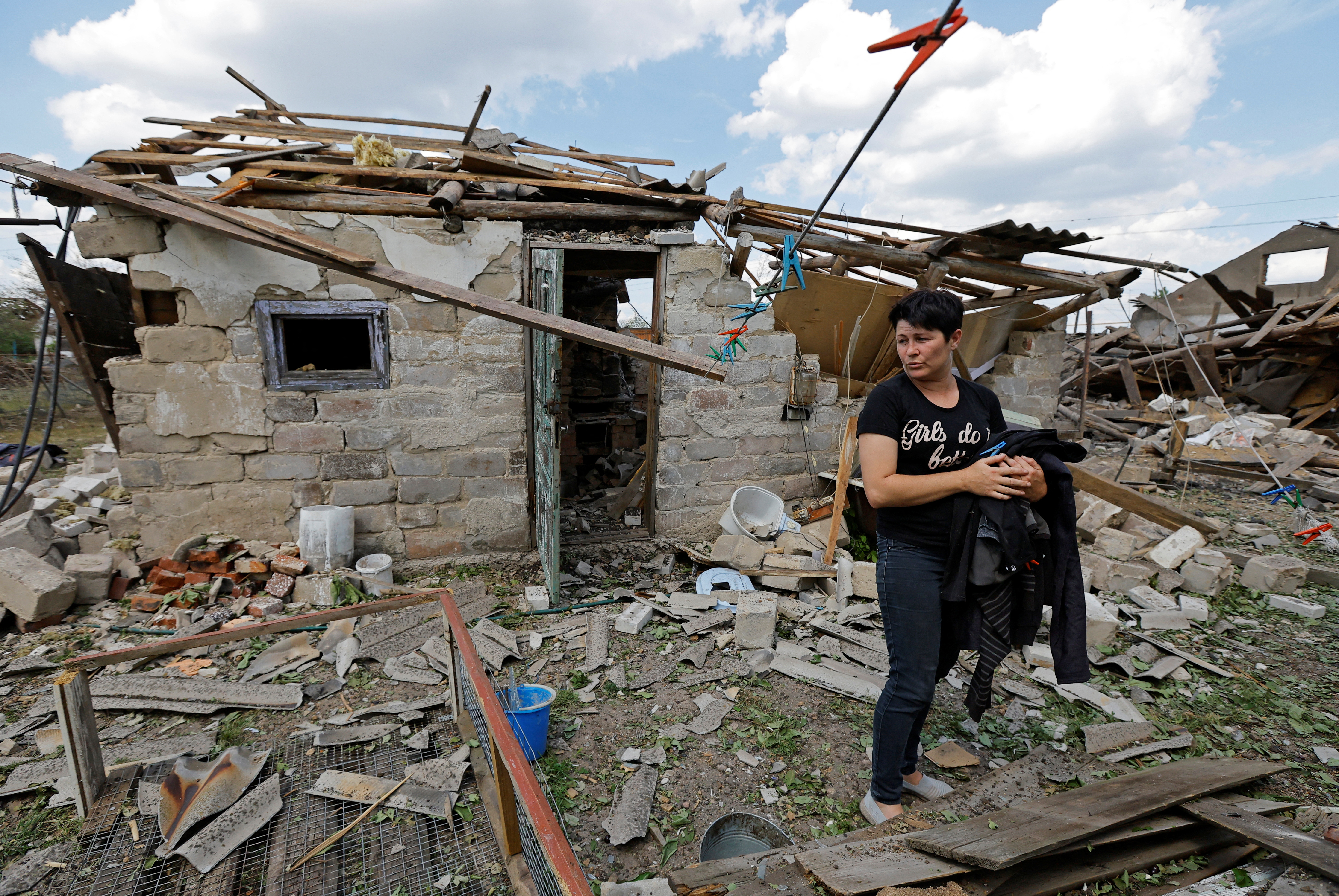 Local resident Marina Isakova, 44, stands near her destroyed house and outbuildings following recent shelling in the course of Russia-Ukraine conflict the village of Rozivka (Rozovka) in the Donetsk region, Russian-controlled Ukraine, June 3, 2024. REUTERS/Alexander Ermochenko